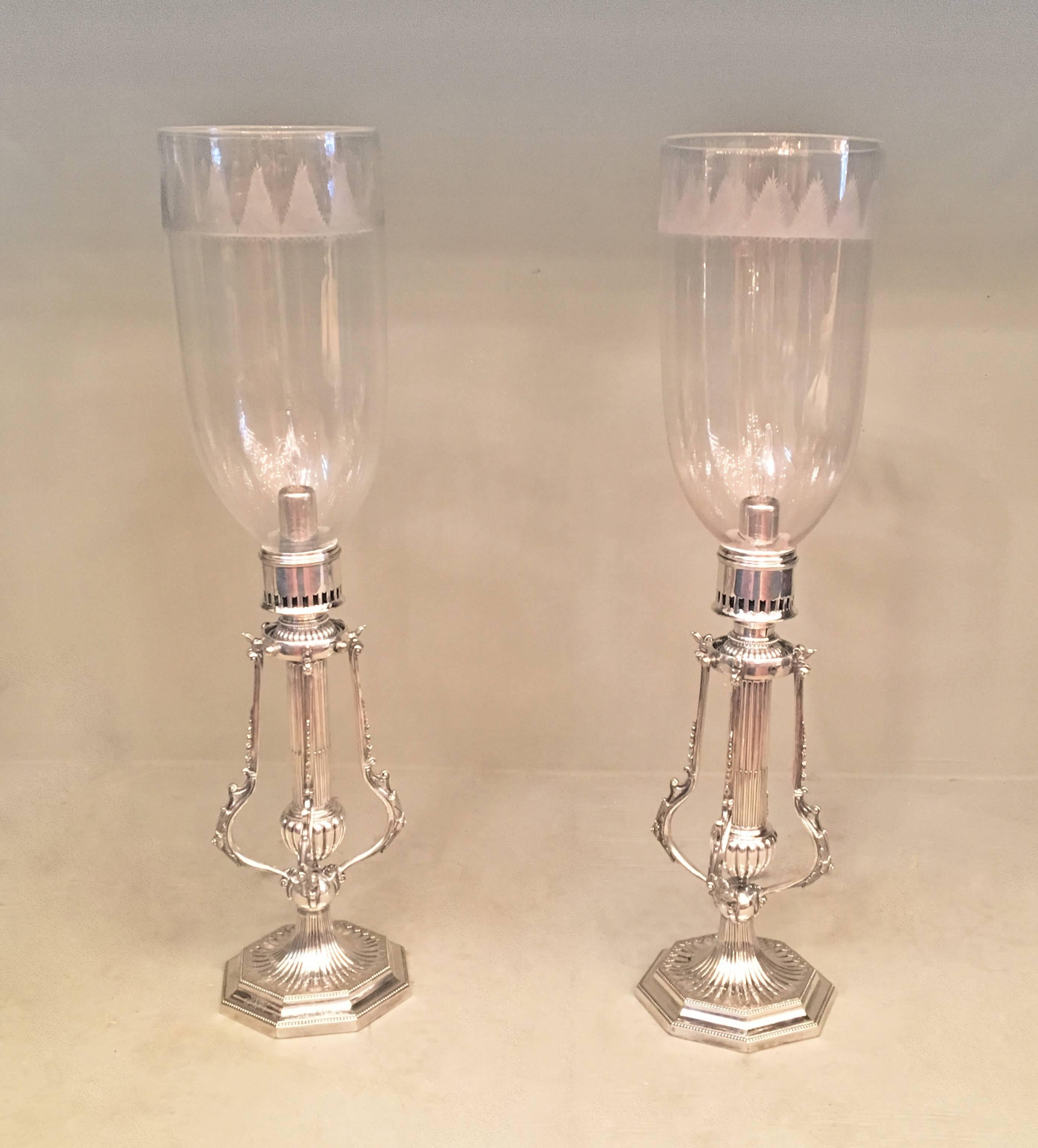 Pair of 19th century English Regency Hurricane candlesticks with savers that were made to pivot with the motion of the ship. Silver plated base monogrammed with three generations as they were passed down.