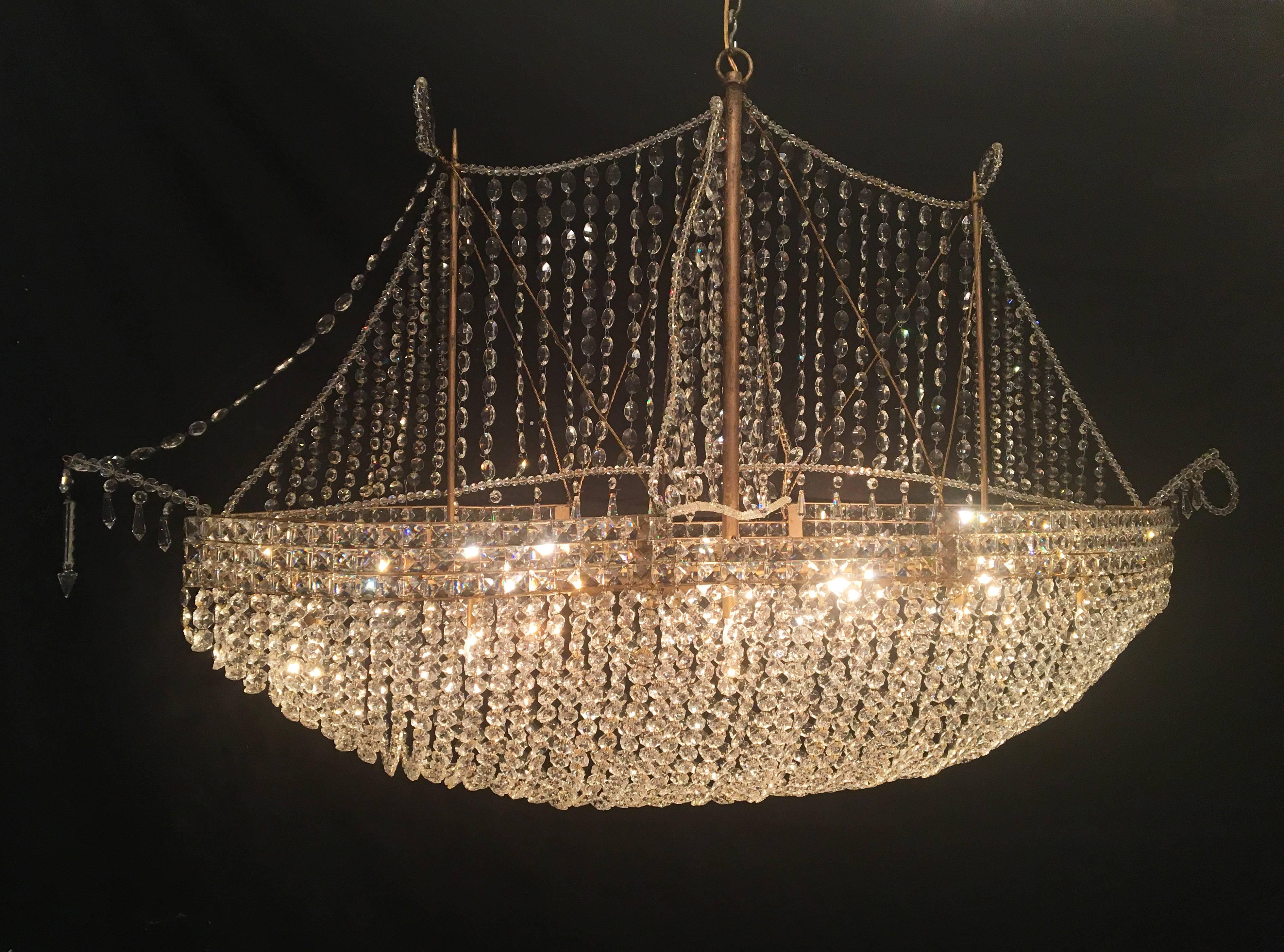 This stunning French crystal chandelier stretching 5 feet in length is sure to make a statement. The chandelier has recently been cleaned and rewired with porcelain sockets.