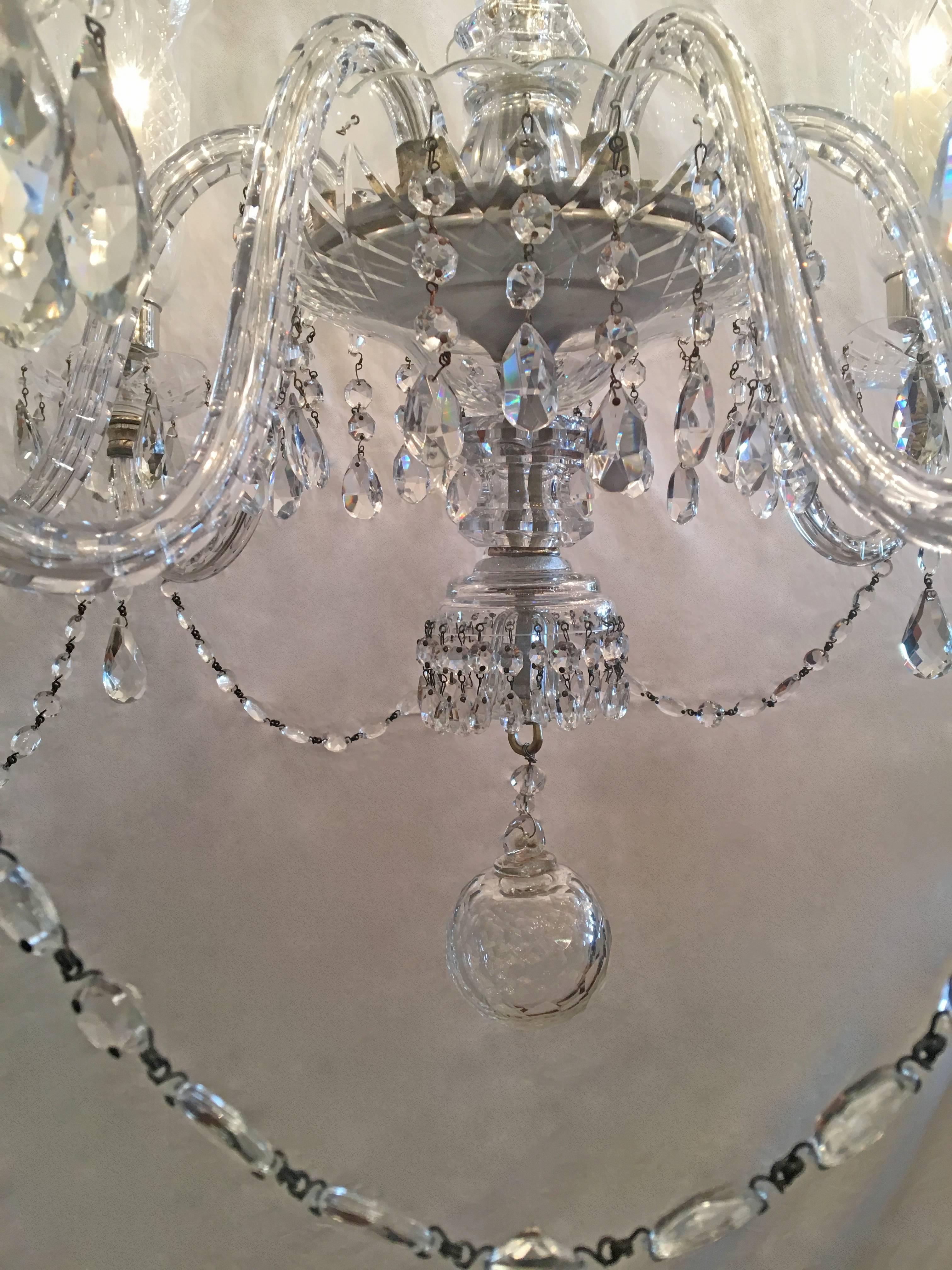 This grand early 20th century George 2nd style Irish crystal chandelier has seven arms with hand-cut detailed silver plated hurricane shades. The chandelier has been rewired with porcelain sockets.
Chain and canopy are included with the chandelier.