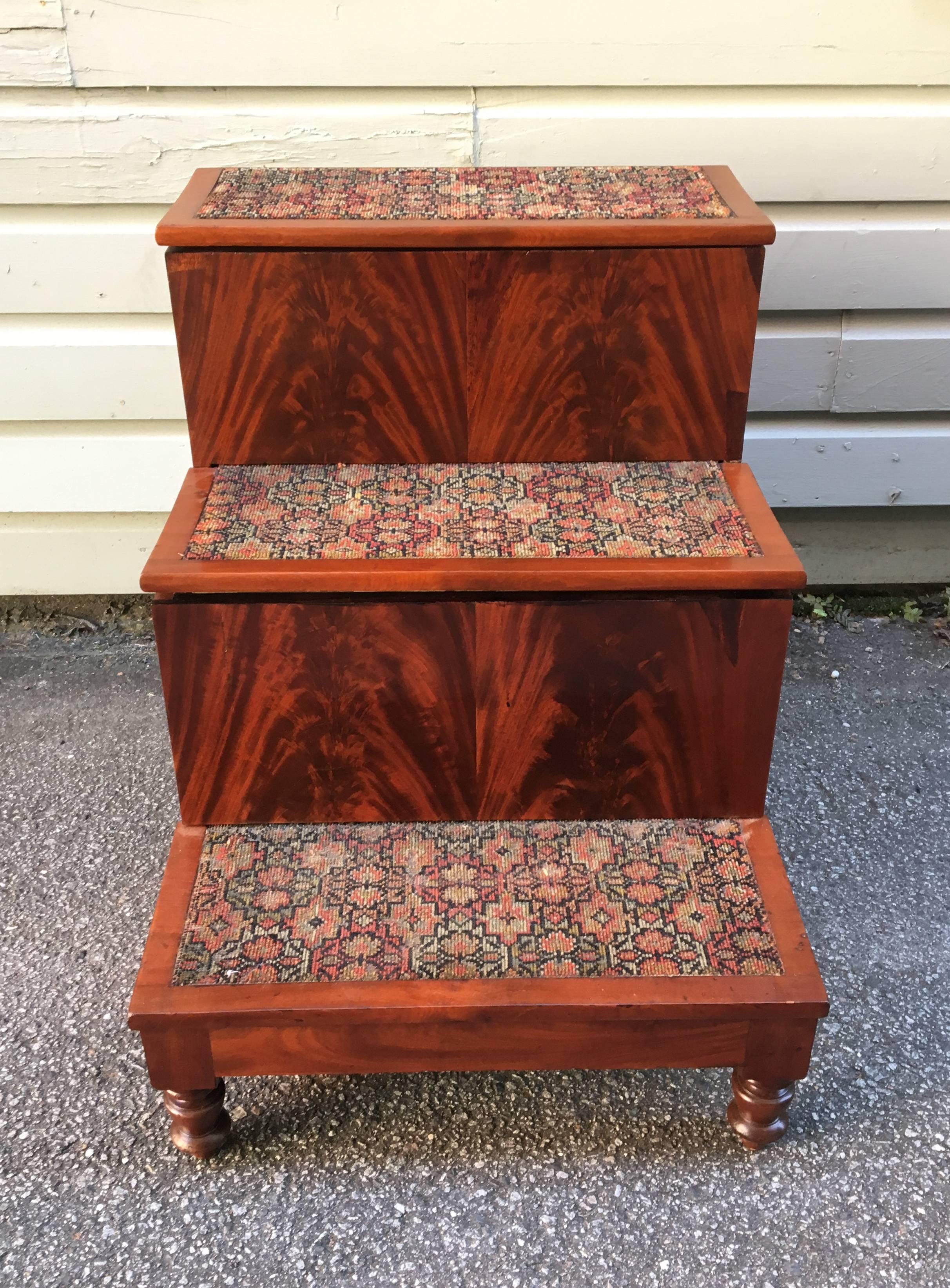 These Southern American bed steps have bookmatched flame mahogany on the risers. The turned Federal legs are solid mahogany and the case is mahogany veneer on poplar and white pine. The steps were originally purchased in Charleston, South Carolina,