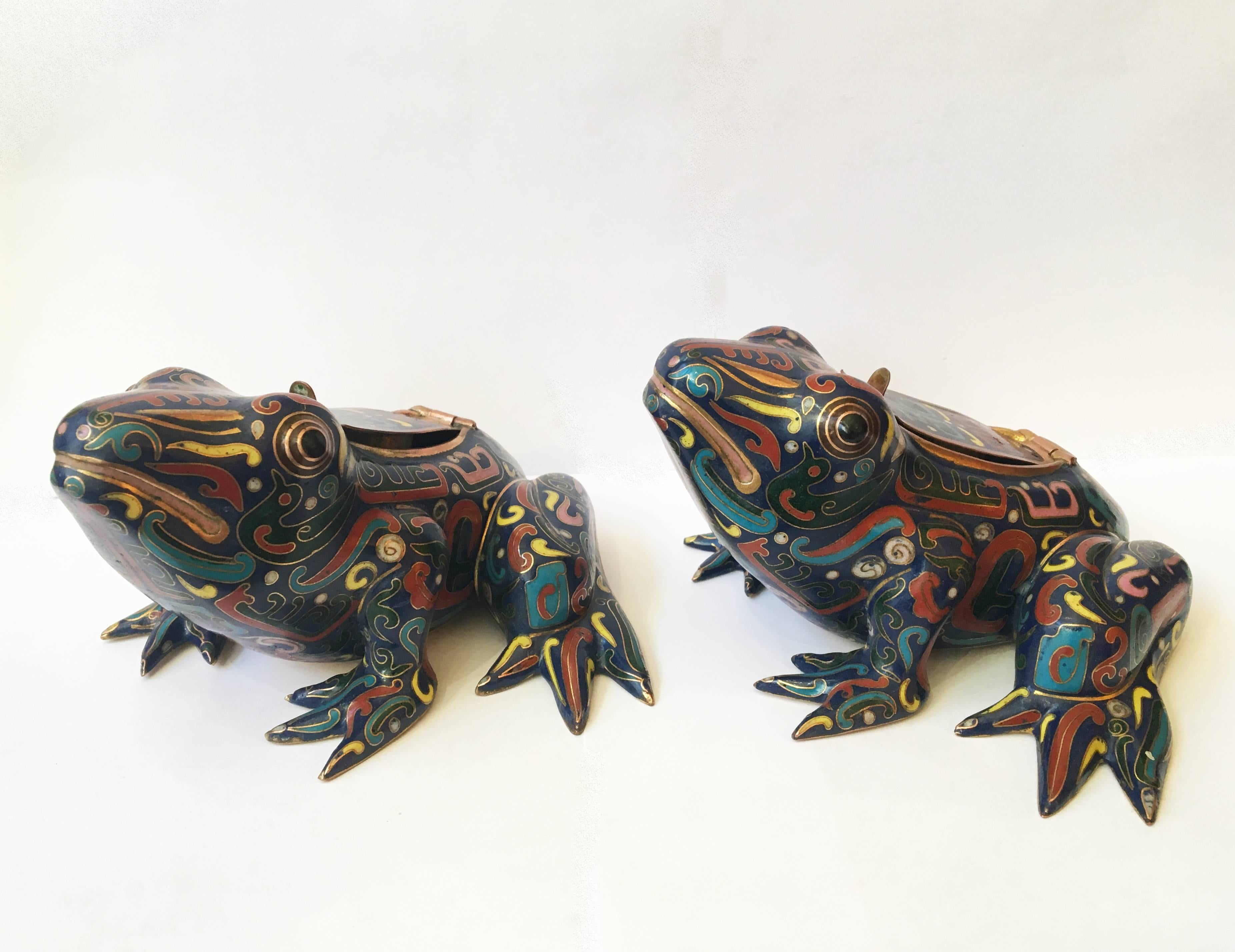 These colorful 20th century pair of cloisonné frog sculptures open to reveal small candleholders.