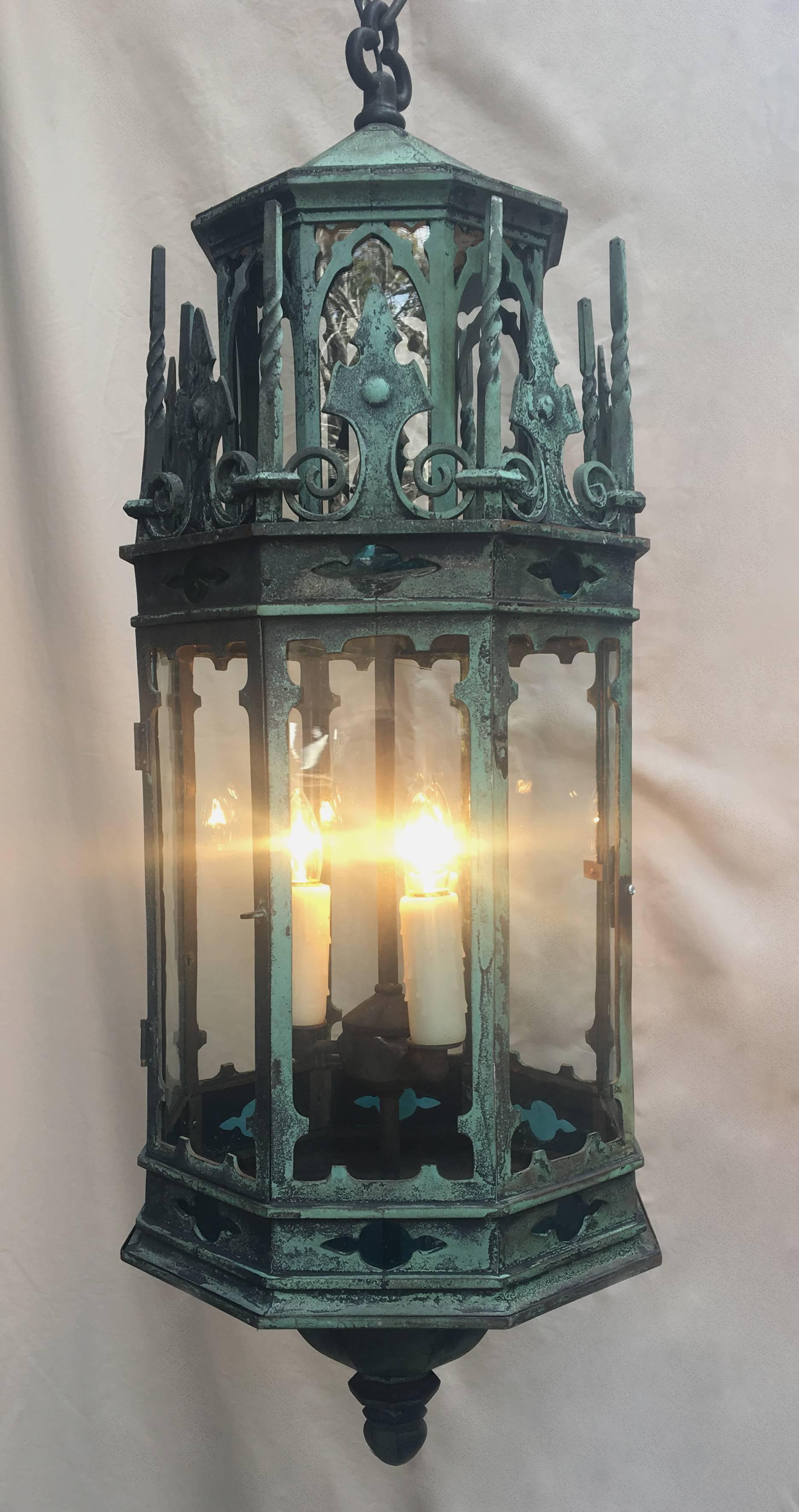 This mid-19th century English Gothic Revival bronze and glass lantern chandelier is accented with turquoise glass. Originally gas, this lantern chandelier has since been rewired and electrified.

Item comes with chain and canopy.