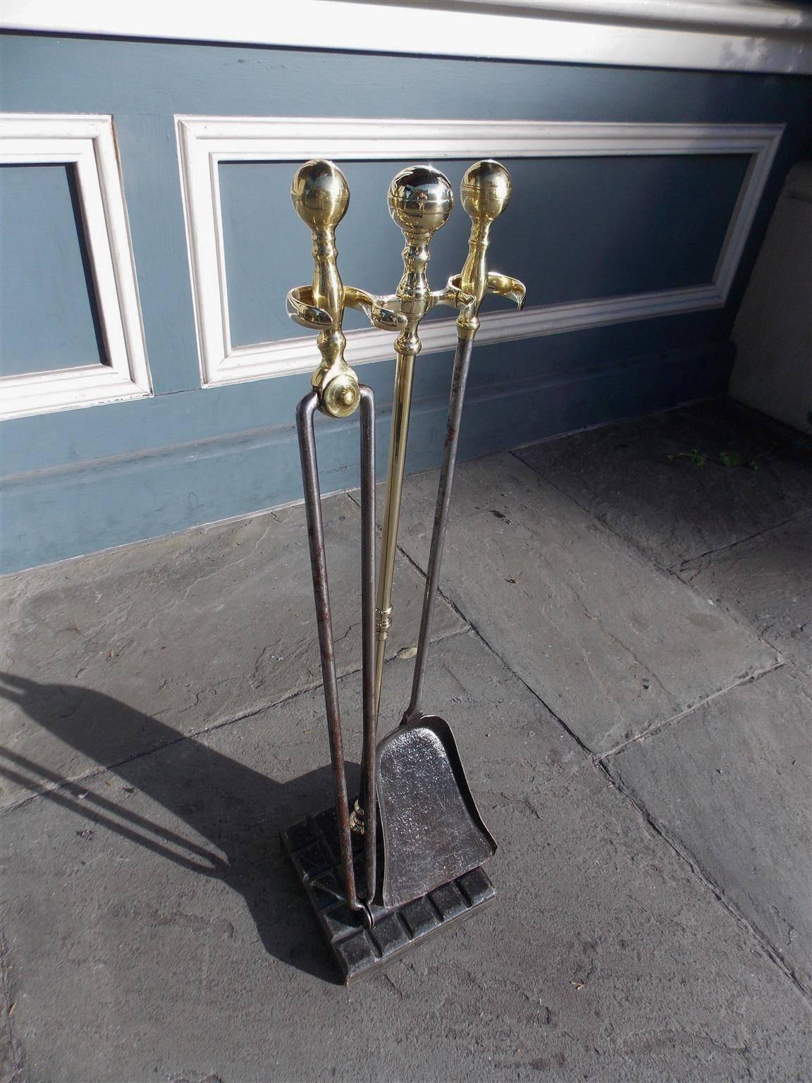 Set of American brass and polished steel fire tools on stand with brass ball turned ribbed finials, a matching ball finial jamb hook, polished steel shafts, and resting on a squared marble gouged base. Set consist of tong and shovel. Early 19th