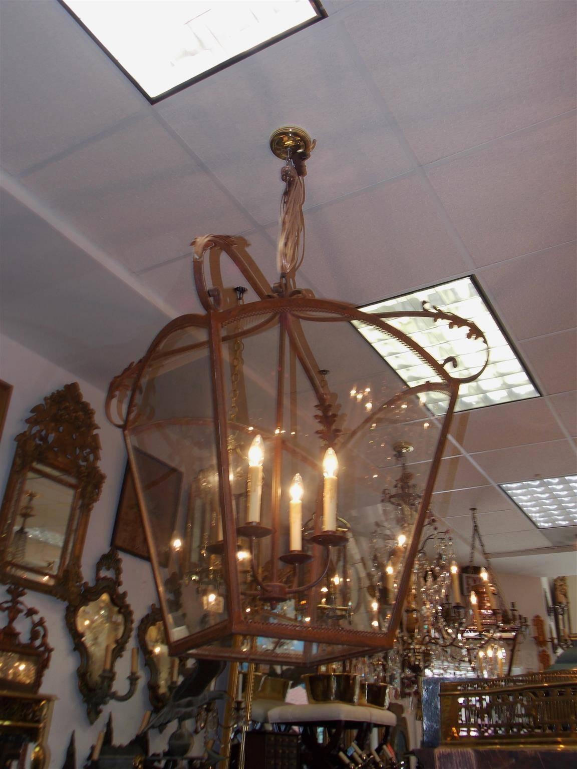 Italian wrought iron hanging glass four sided arched dome lantern with pleasing pierced gallery, decorative scroll acanthus motif, and a four-light interior cluster, Late 19th century. Lantern was originally candle powered and has been electrified.