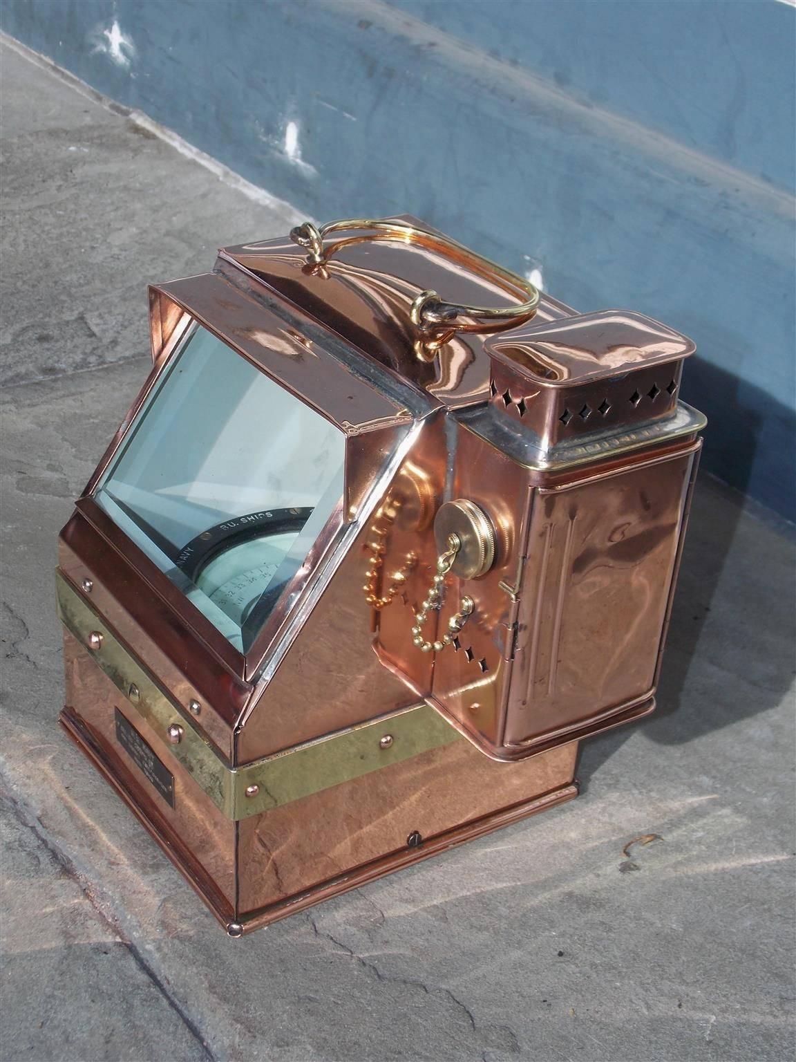 American solid copper and brass Navy ships binnacle with interior mounted compass, brass carrying handle, side mounted kerosene lantern, rear mounting bracket and brass plate inscribed “U.S. NAVY / BU. OF SHIPS / THE LIONEL CORPORATION / NEW YORK”.