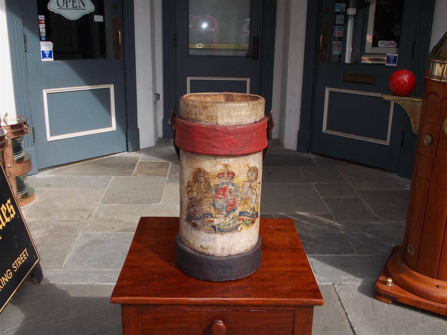 British Royal Navy leather shot bucket with the original carrying handle, circular lined interior and decorated on the exterior with a colorful painted coat of arms, royal crown, flanking lion, and unicorn and Latin script, Early 19th Century.