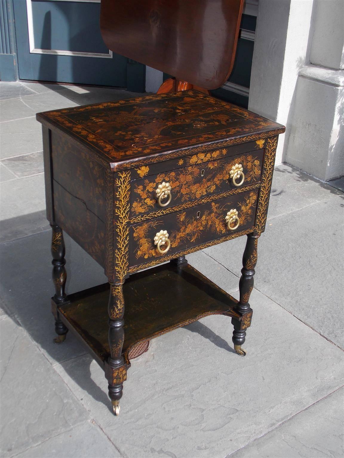 Fine American black lacquered & Japanned two drawer stand with original gilt floral brasses, lower shelf, and terminating on turned bulbous legs with the original brass casters. New York, Early 19th Century. Secondary wood consist of white pine and