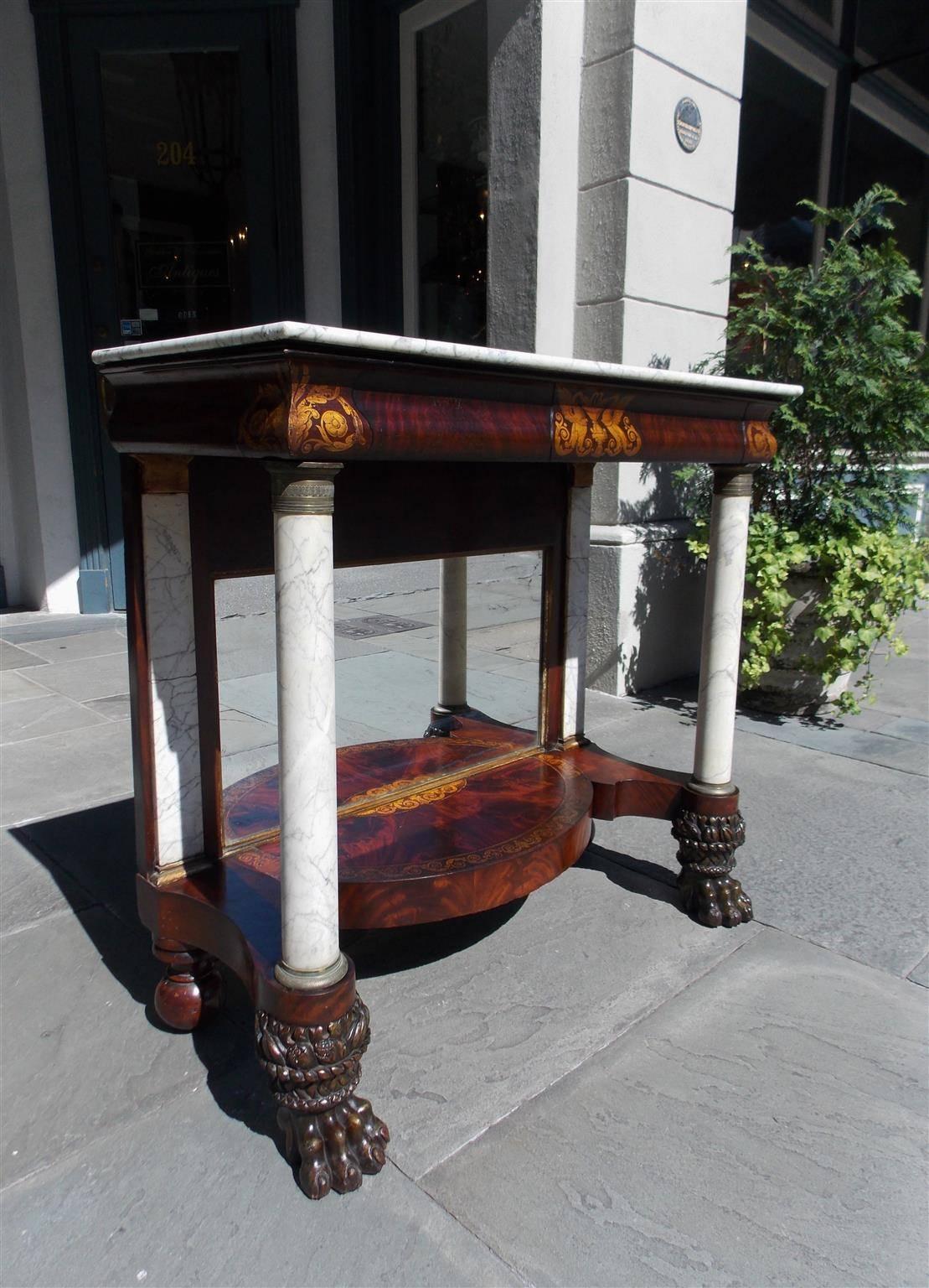 American mahogany marble-top console with gilt stenciled floral motif, original gilt ormolu mounts, marble columns and terminating on the original turned bulbous ball and lions paw feet. All Original . Early 19th century. Console retains the