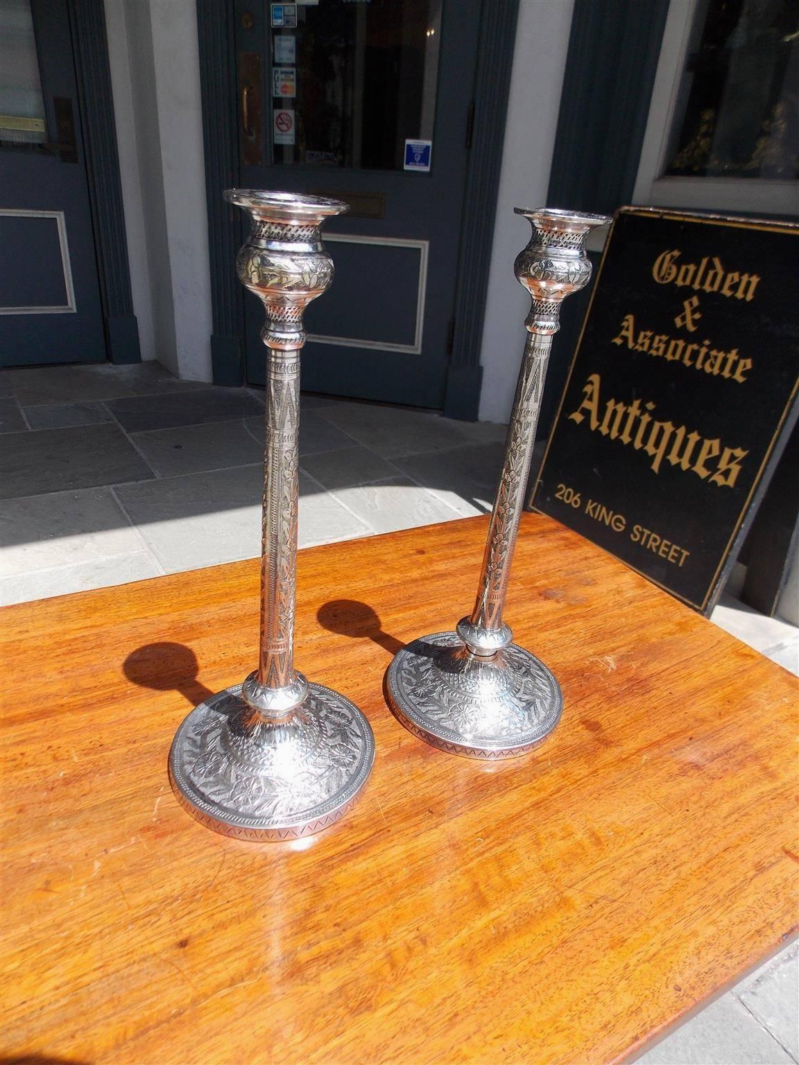 Pair of English candlesticks with hand chased floral bulbous bobeches, beaded & floral decorative chased columns, and terminating on circular chased cross hatching floral bases, Late 18th century.