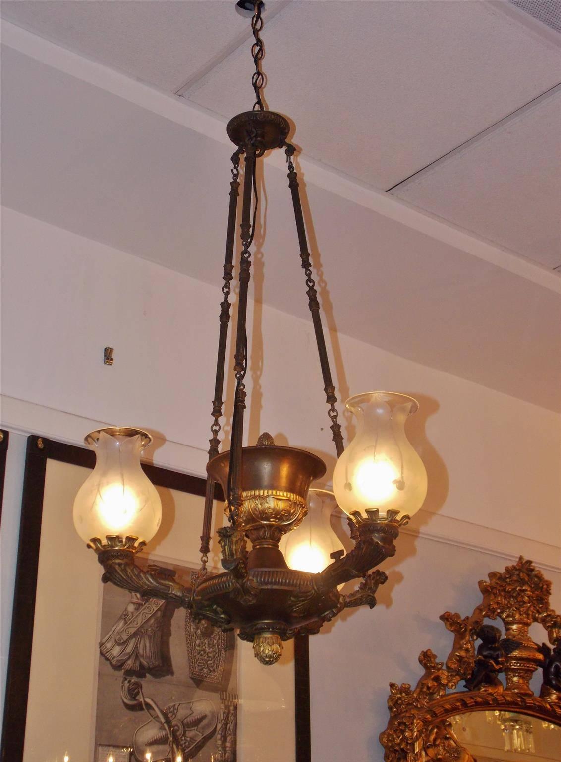 French gilt bronze three-arm argand chandelier with centered urn reservoir, original keys, original bulbous frosted etched globes, and filigree floral motif. Chandelier was originally gas and has been electrified, Early 19th Century.