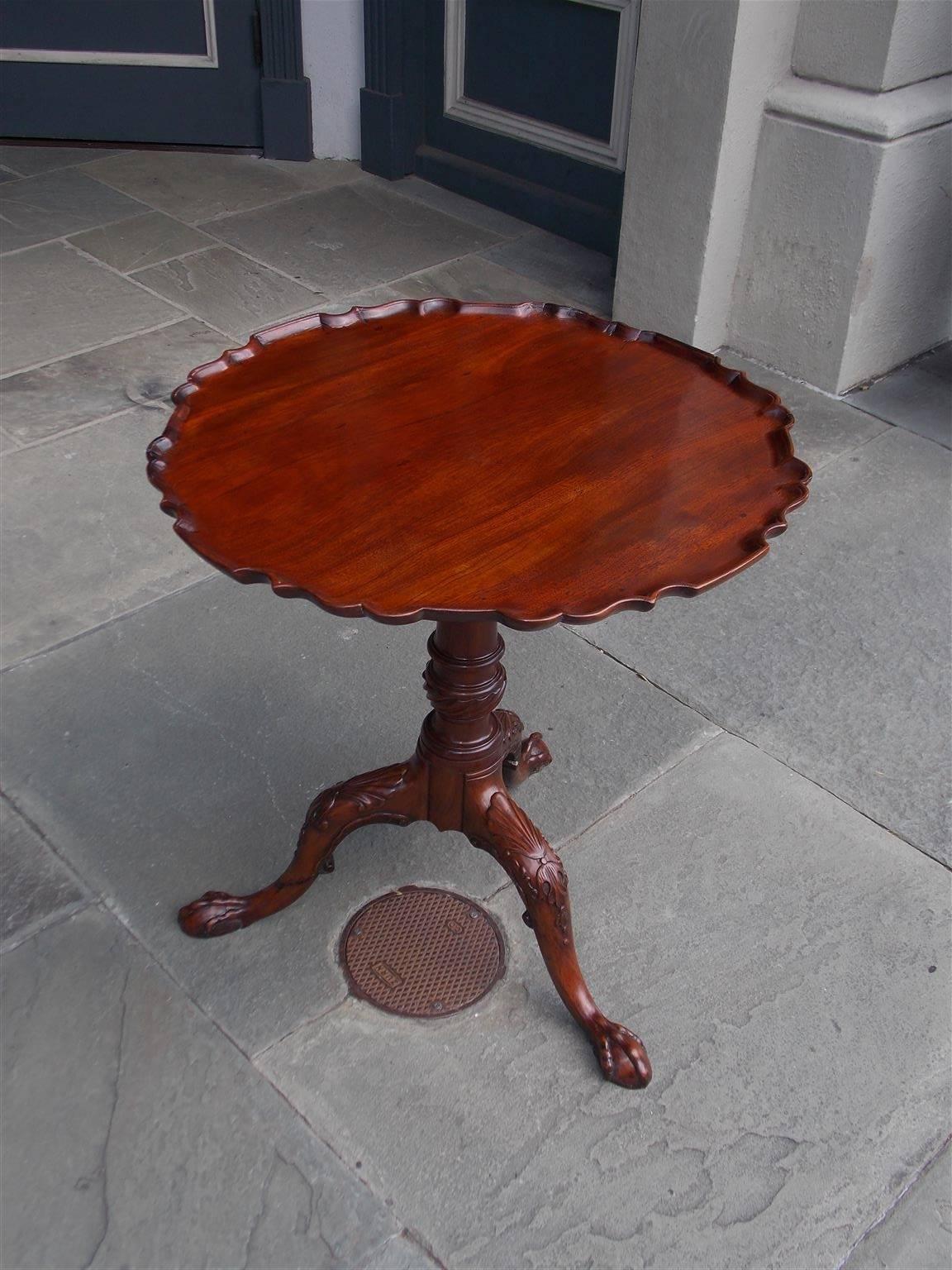 Scottish mahogany tilt-top tea table with carved molded edge top, centered rotating bird cage, original locking mechanism, carved turned ringed spiral pedestal and resting on tripod legs with carved shell floral knees on claw and ball feet, Mid-18th