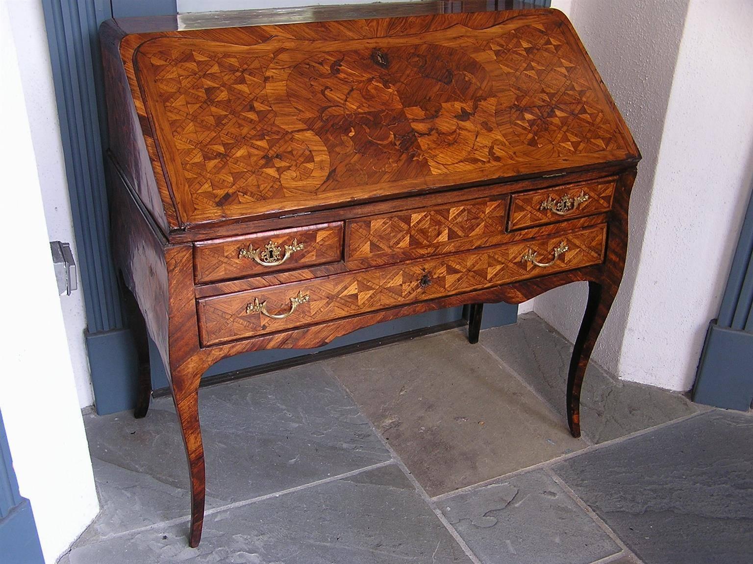 French marquetry ladies slant top three-drawer writing desk with floral motif inlay, flanking step back interior drawers, leather writing surface, carved scalloped skirt, original ormolu brasses and terminating on tapered cabriole legs, Late 18th