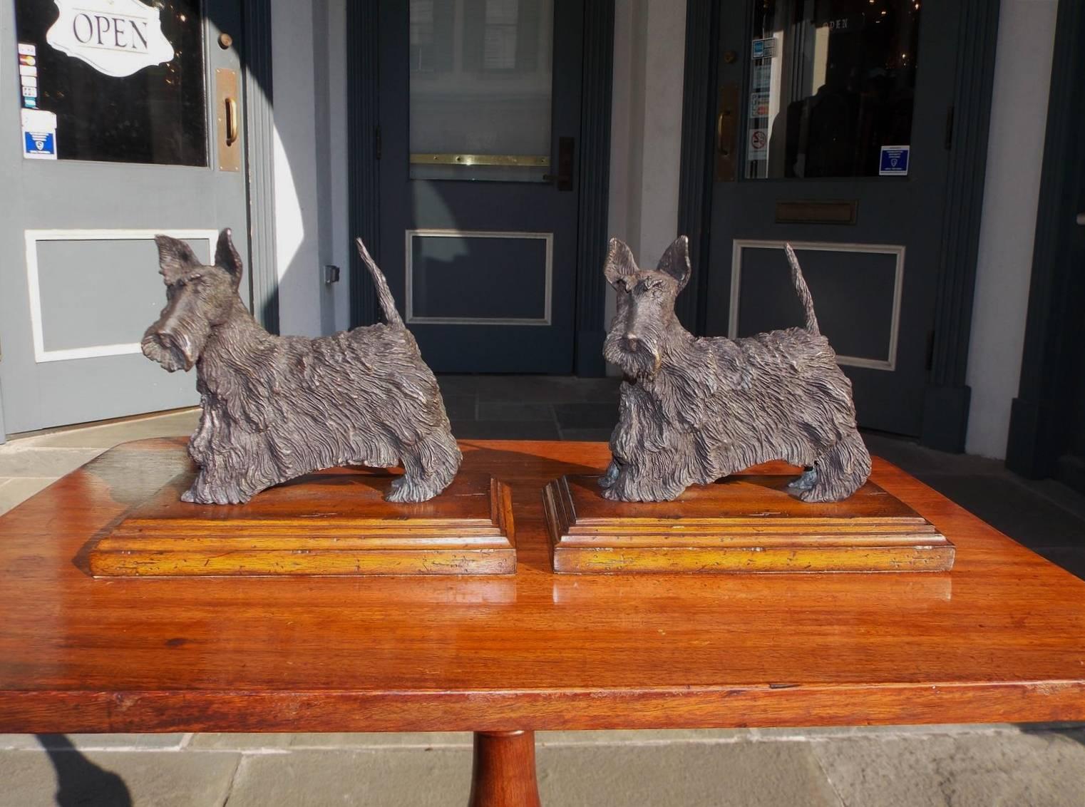Pair of French bronze Scottish terrier bookends on the original walnut rectangular molded edges bases, Mid-19th Century.