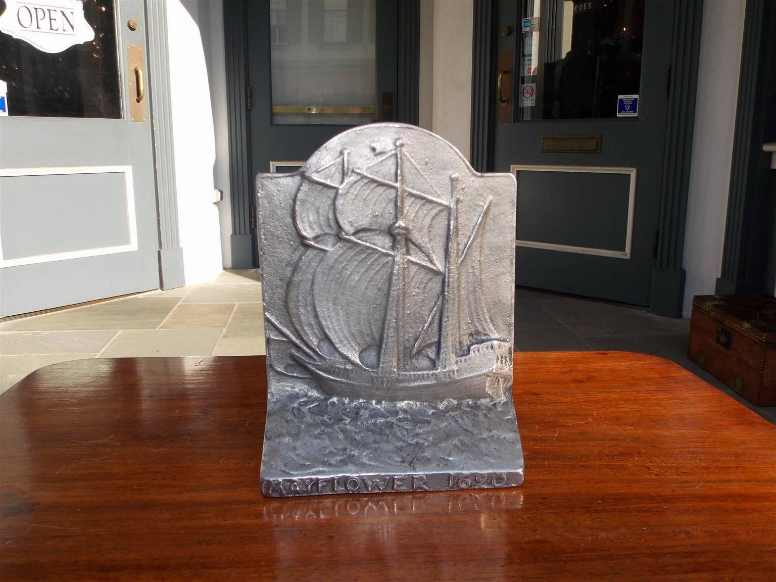 American cast iron Mayflower arched doorstop with sailing vessel on rough seas. Signed on lower base, mayflower, 1620. Late 19th Century.