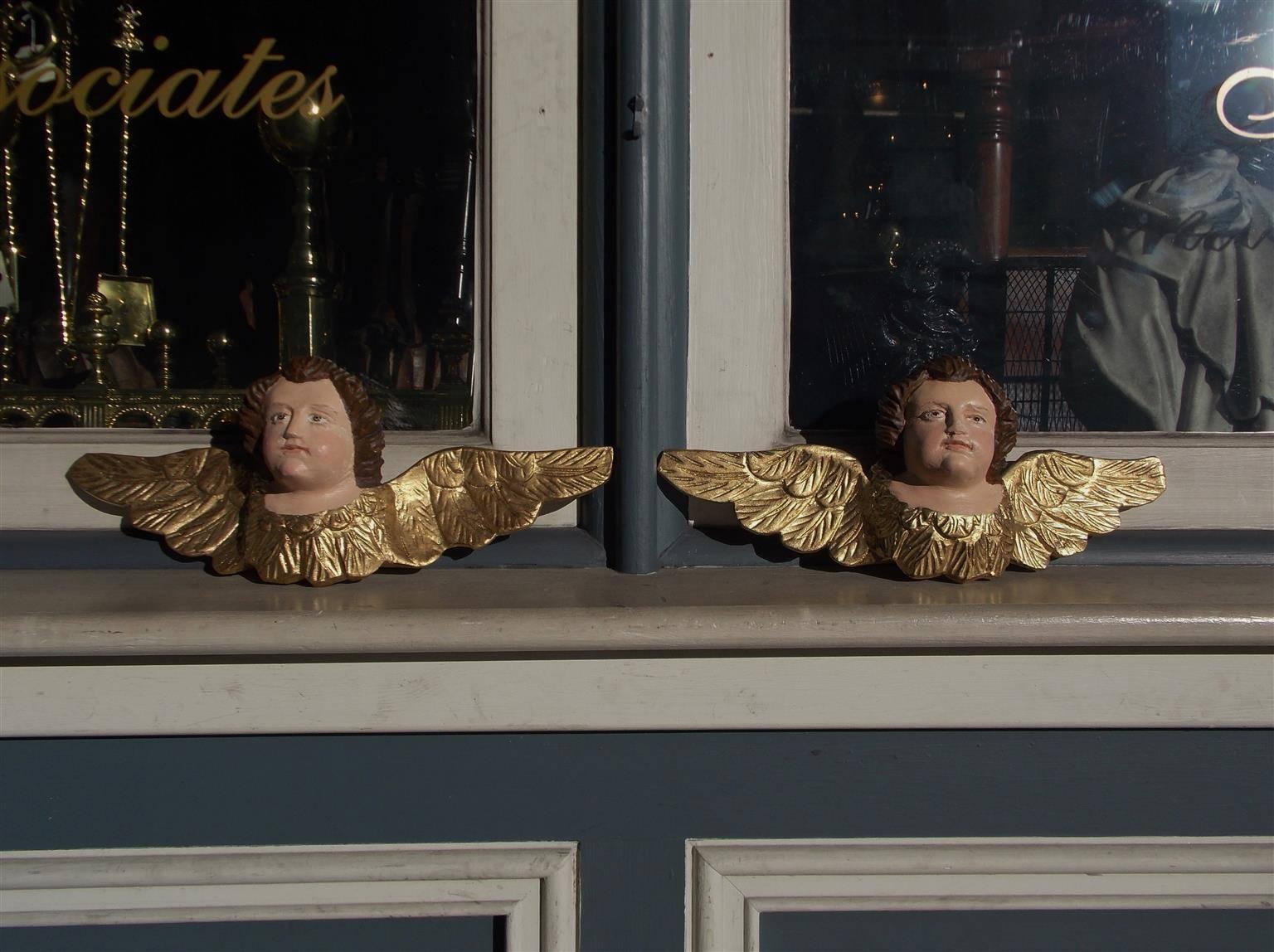 Pair of Italian gilt carved wood, gesso, and painted hanging wall cherubs .  Early 19th Century.