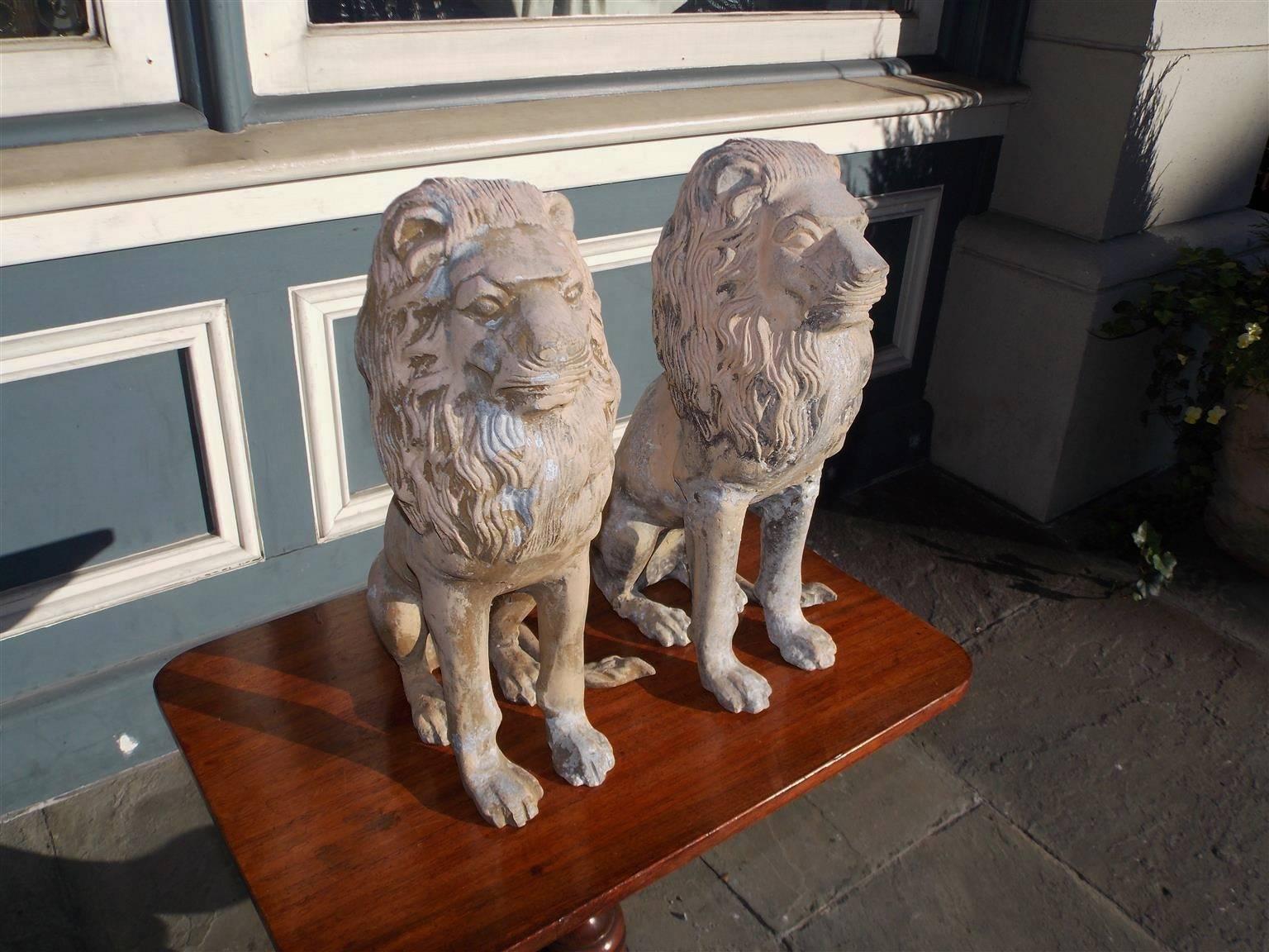 Pair of English cast iron poly chromed sitting lions. Mid-19th century.