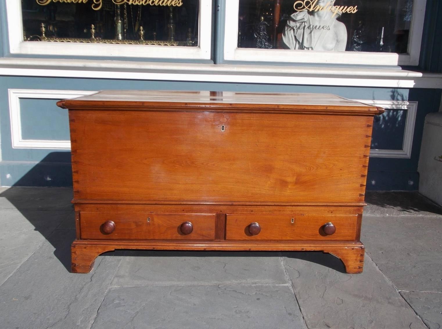 American Chippendale two-drawer walnut blanket chest with a carved molded edge, hinged top, interior till, exposed dovetail, and resting on the original bracket feet. Late 18th Century. Secondary wood consist of poplar throughout.