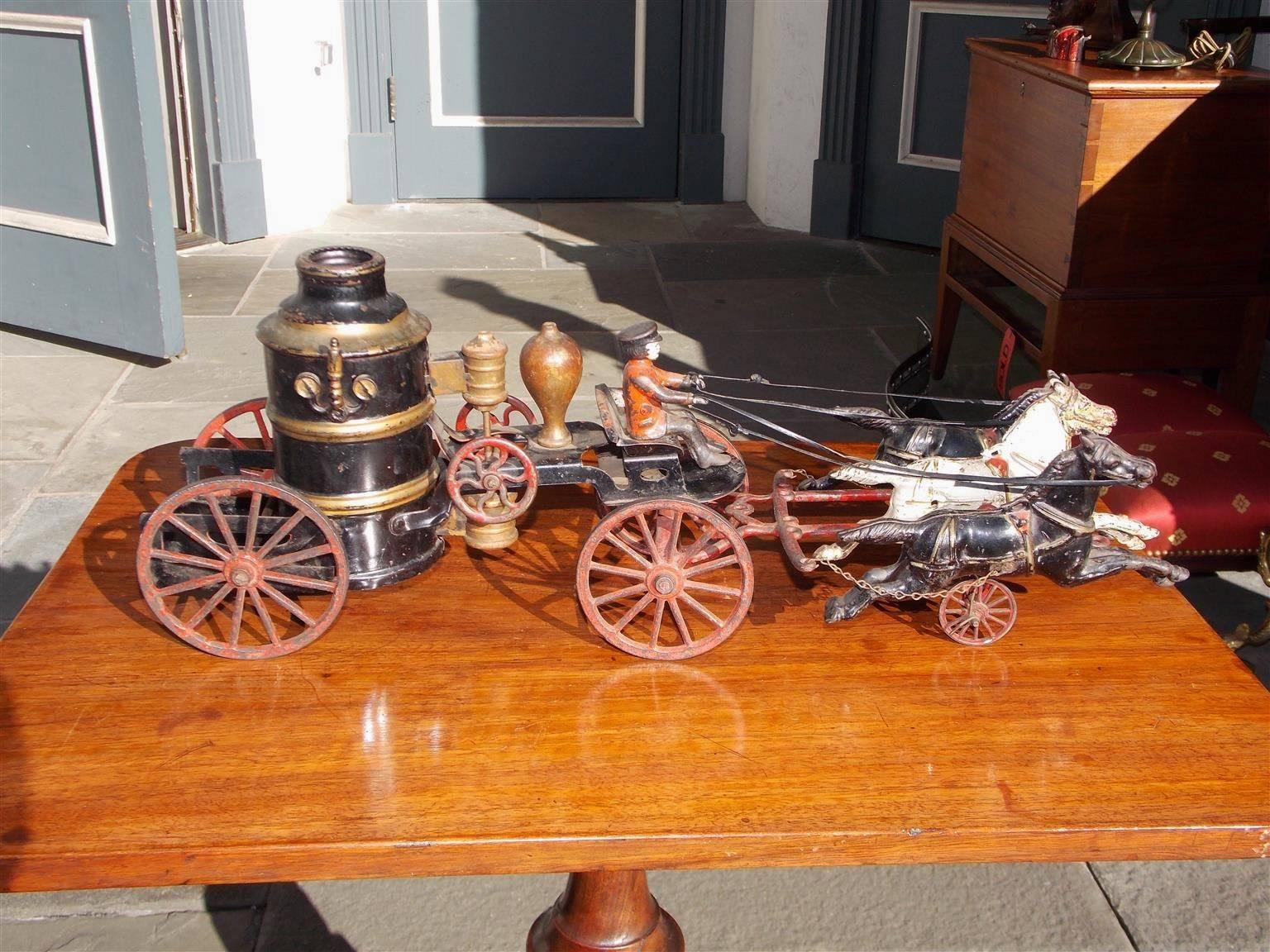 American three horse drawn cast iron and painted fire pump toy wagon. All original, Late 19th century.