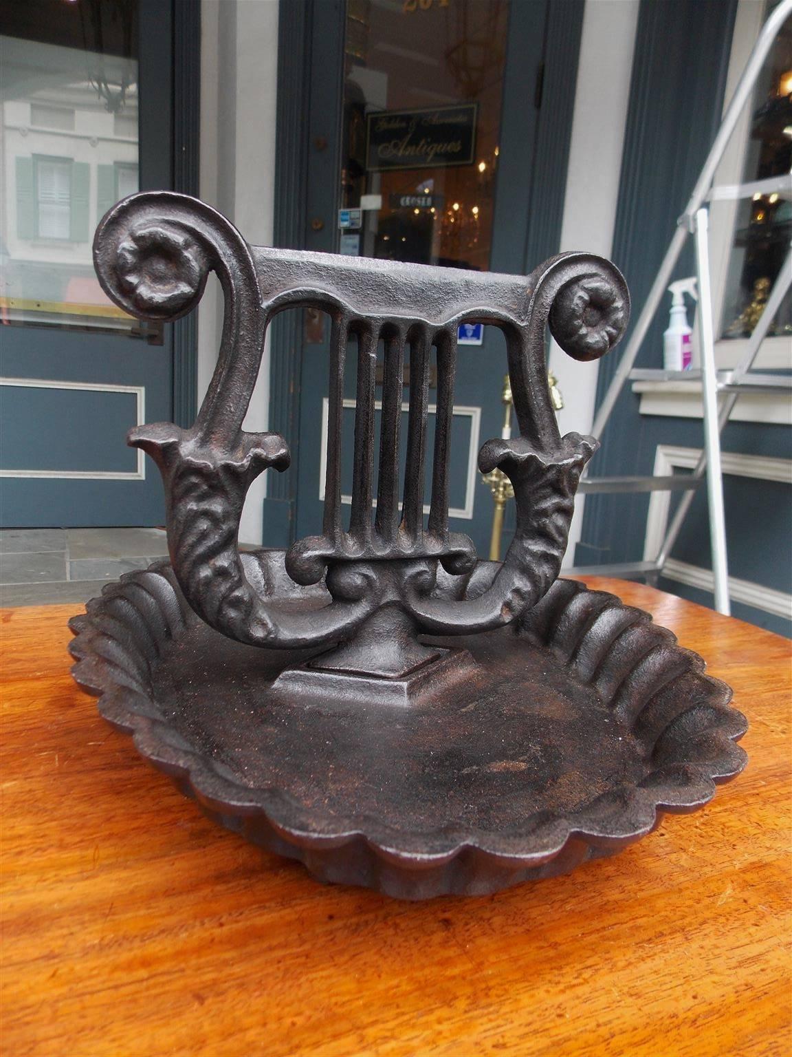 American Charleston cast iron lyre boot scrape resting on a oval scalloped edge base, Early 19th century.