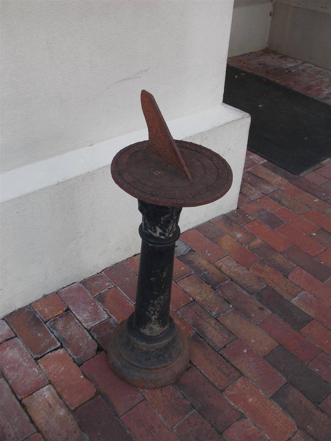 American cast iron sun dial with a painted floral pedestal resting on a circular ringed base, Mid-19th Century. Sundial is 10
