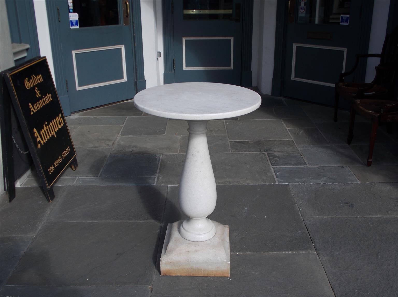 Italian marble top circular garden table with a bulbous ringed pedestal and resting on a squared plinth. All original, Mid-19th Century.  Piece is 14
