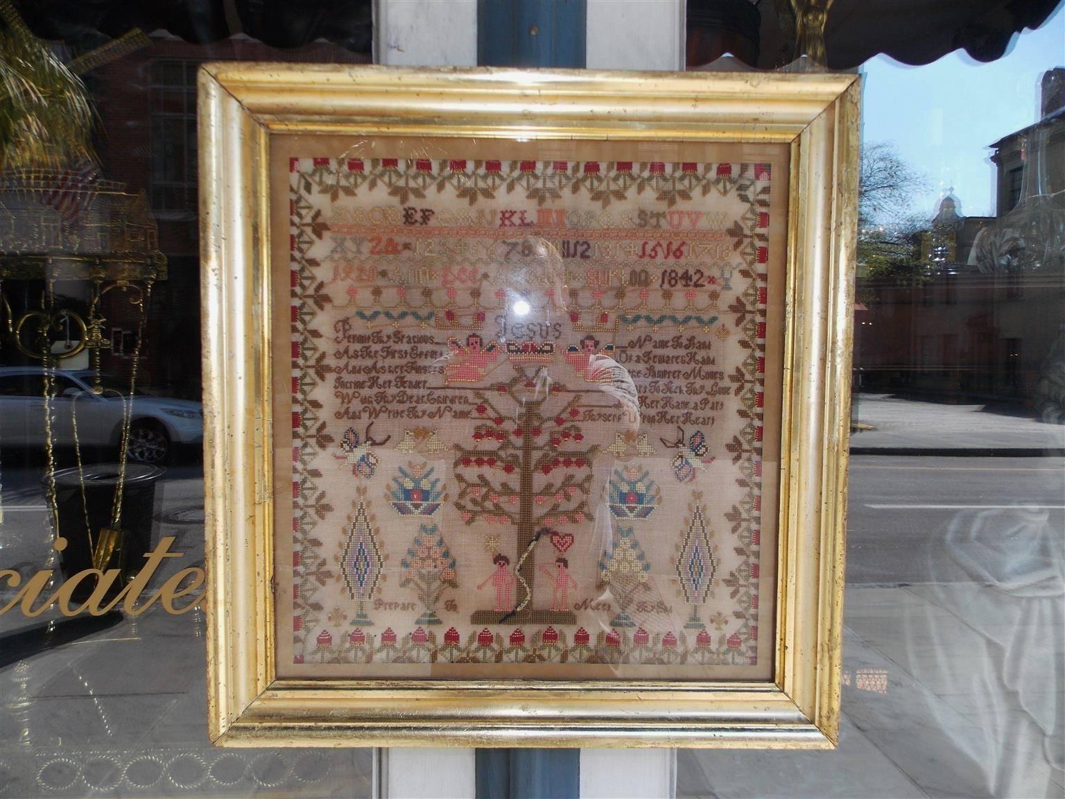 American needlepoint christian themed sampler in the original gold gilt frame under glass. Tree of knowledge good and evil. Adam and Eve with the serpent. Worked by Ann Lee Burtin, age 14, dated 1842.