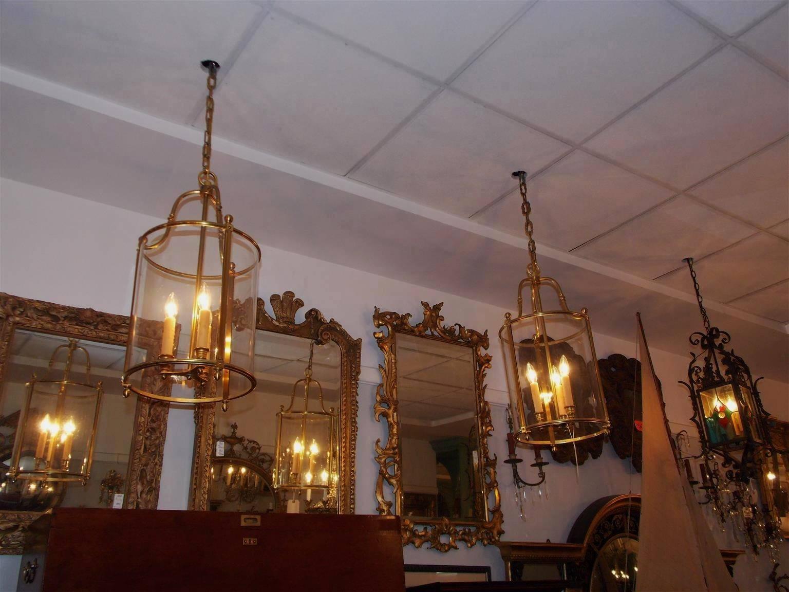Pair of American brass hanging glass lanterns with scrolled arms , three light cluster, and terminating with stylized lemon finials. Originally candle powered, Late 19th century.
