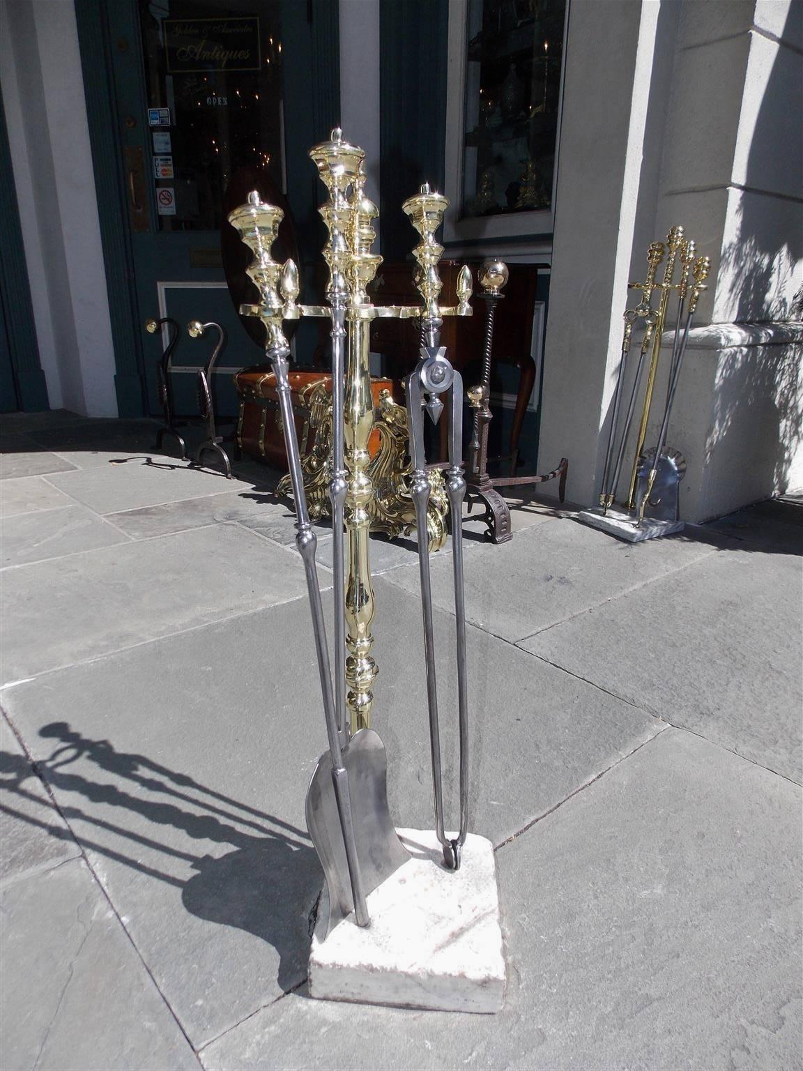 American brass and polished steel fire tools resting on a turned urn finial marble stand. Set consist of poker, tong and shovel, Early 19th Century.