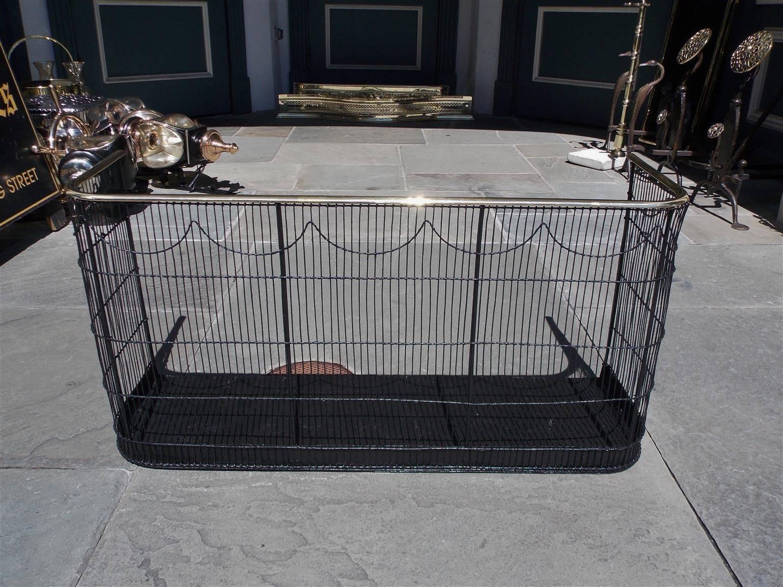 American wrought iron and brass rail top nursery wire fender with connecting swags and interior iron pan, Early 19th century. Pan can be removed if desired by local blacksmith at no additional cost.