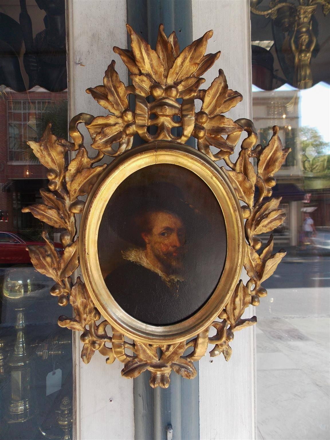 Italian oval oil on board gilt carved wood portrait of a gentleman in the original floral and berry frame, 18th century.