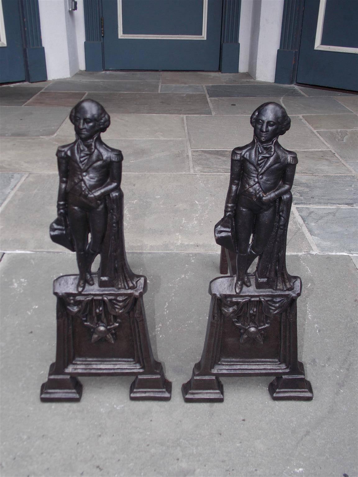 Pair of American cast iron George Washington andirons with GW campaigning in Military attire erected on decorative star plinths with step back feet, Mid-19th century. Depth can be adjusted if desired by local blacksmith at no additional cost.