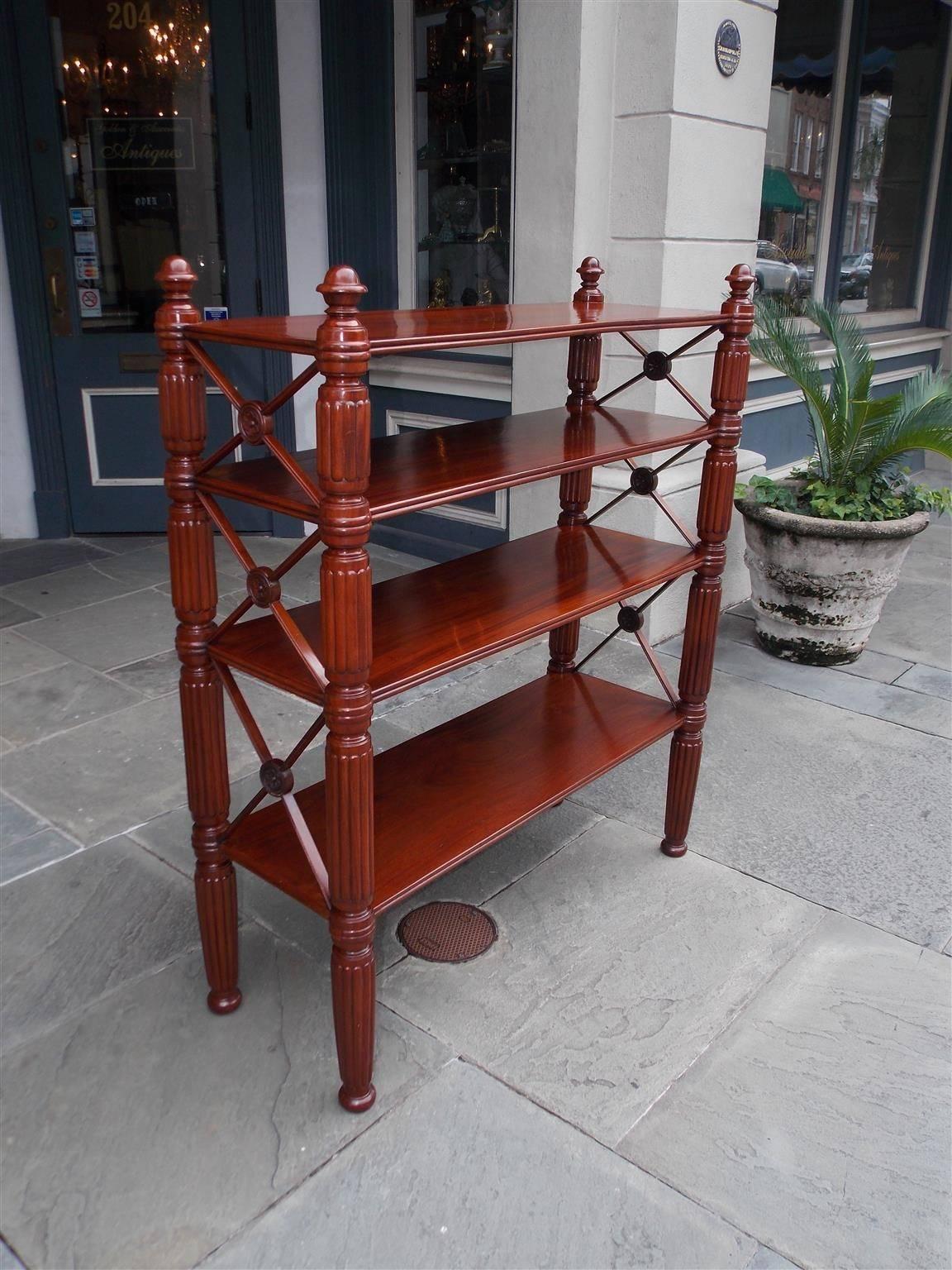 Caribbean regency mahogany four tier bookshelf with turned bulbous stylized acorn finials, reeded ringed side columns, cross hatching with centered floral medallions, and terminating on bun feet, Early 19th century.