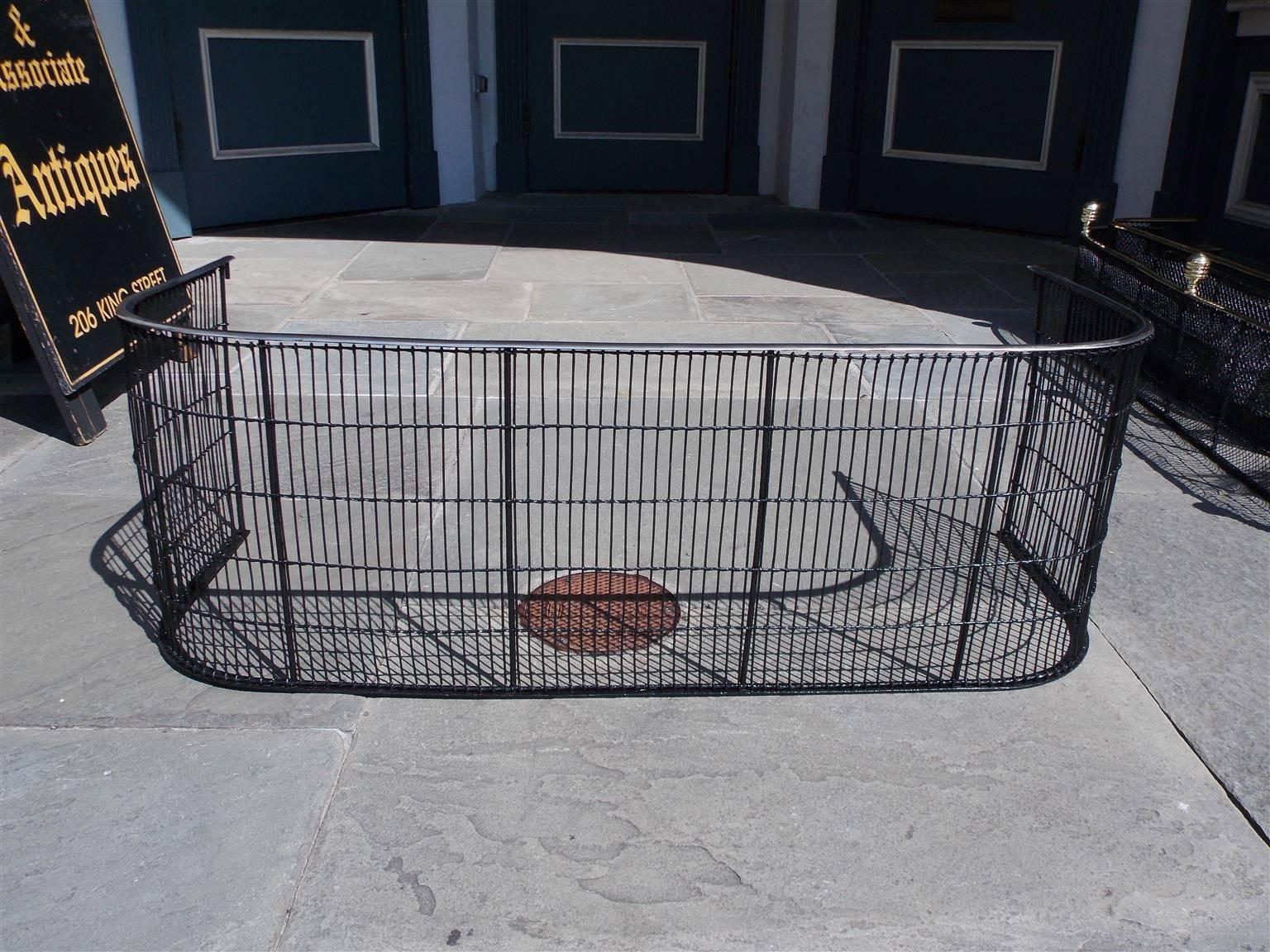 American wire and polished steel fire place fender with centered iron supports and wrought iron base, Early 19th Century.