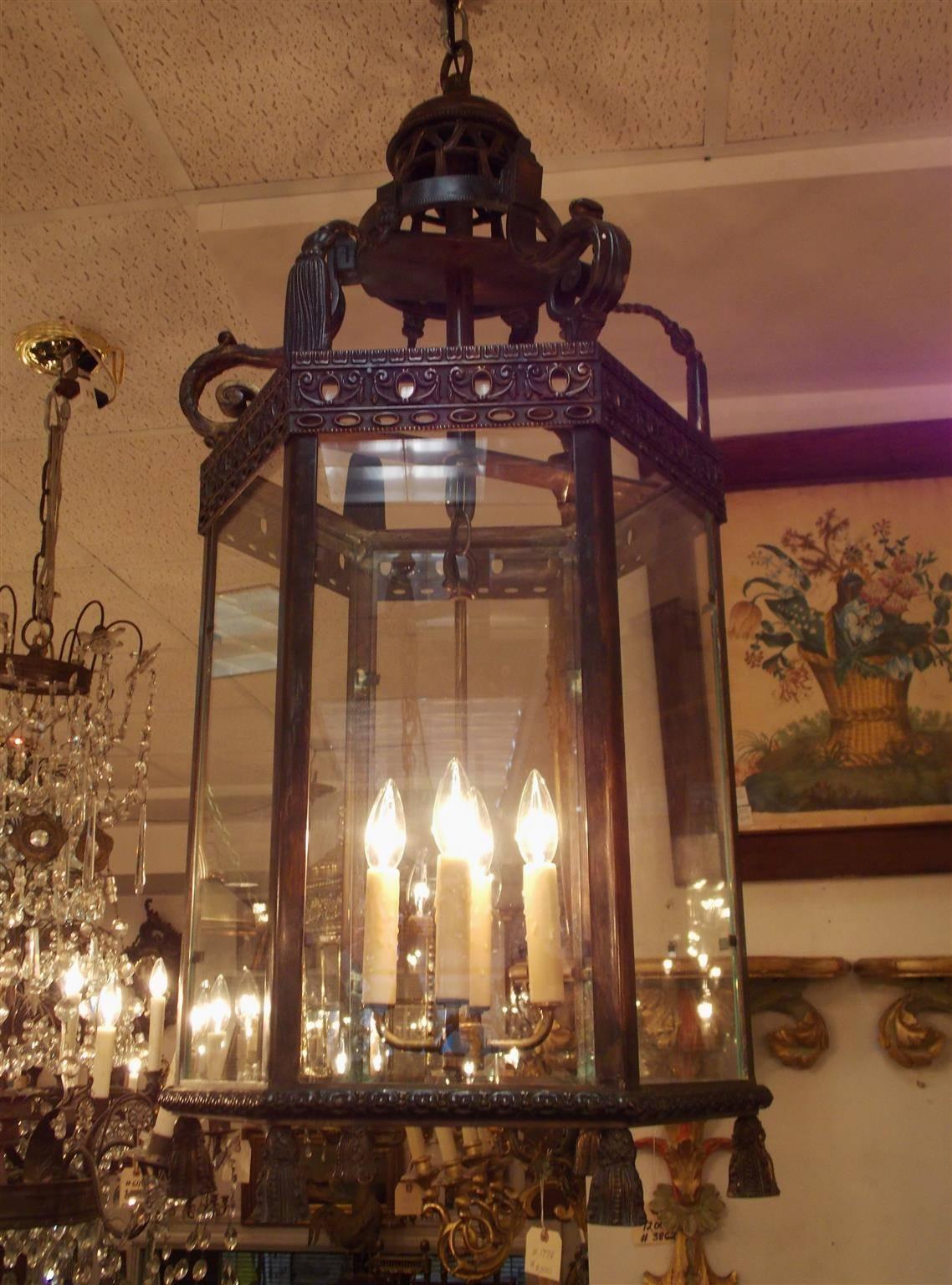 Italian bronze hexagon glass hanging hall lantern with decorative scrolled arms, filigree upper border, four interior light cluster, and terminating with six lower decorative tassels, Early 19th century. Lantern was originally candle powered and has