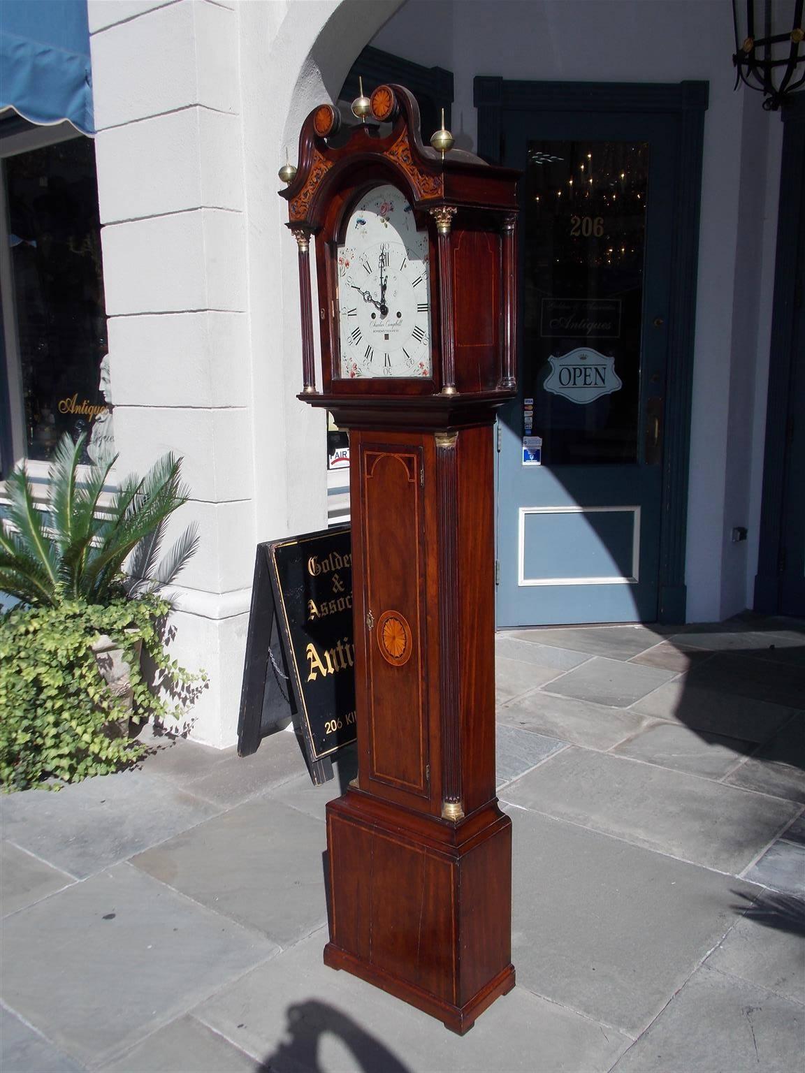 Scottish mahogany eight day tall case clock with three sphere brass finials, a swan neck satinwood inlay patera pediment, intricately carved fretwork, over an arched door with flanking Corinthian fluted columns, Satinwood inlaid patera trunk with