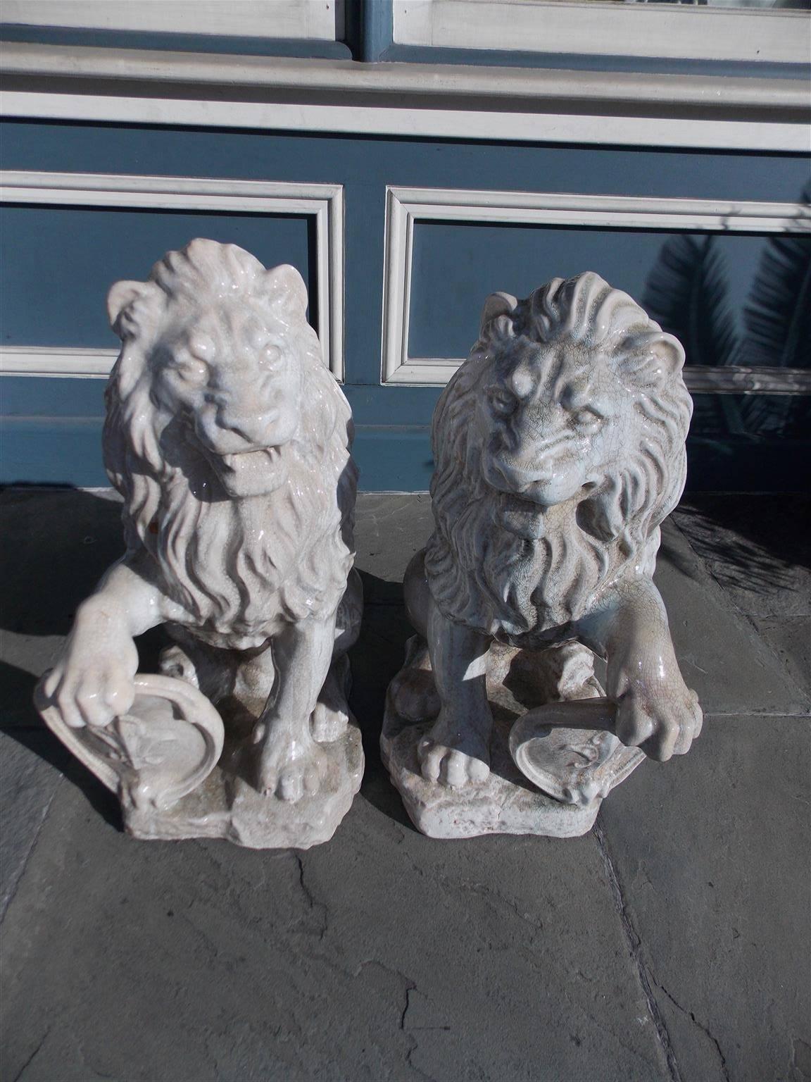 Pair of French Glazed Terracotta Lions Grasping Fleur De Lis Plaques, Circa 1840 In Excellent Condition In Hollywood, SC