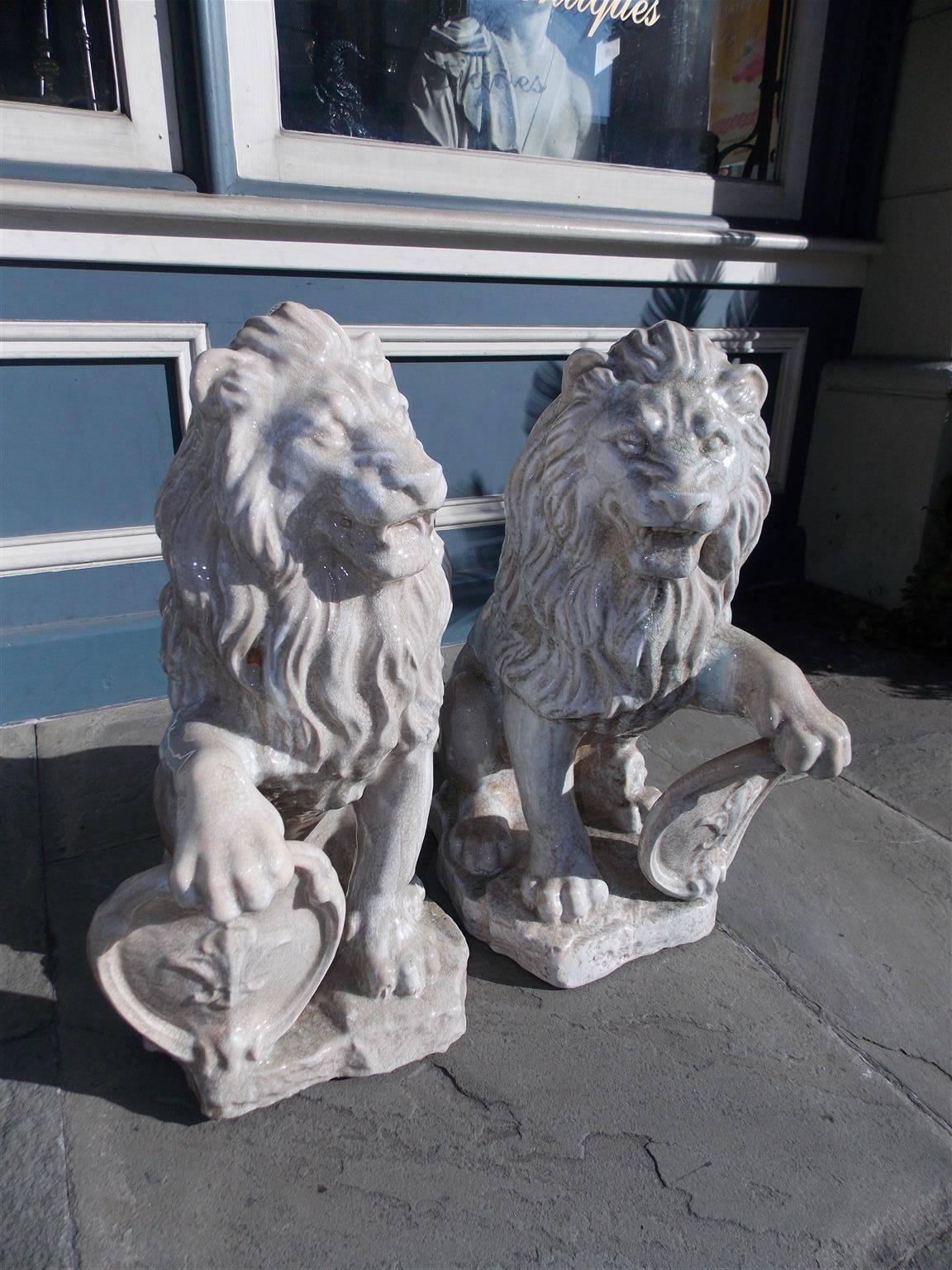 Hand-Carved Pair of French Glazed Terracotta Lions Grasping Fleur De Lis Plaques, Circa 1840