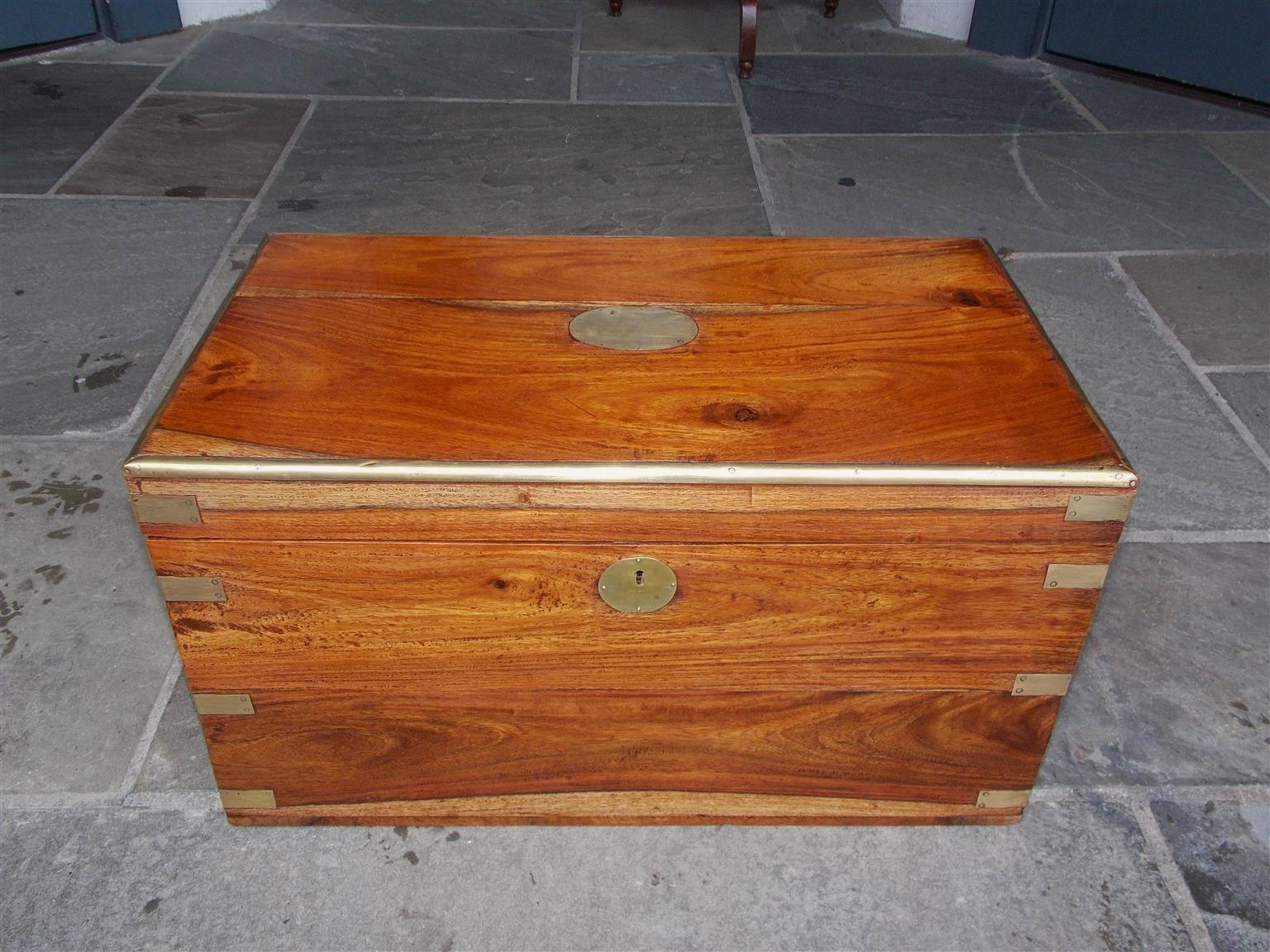 English camphor wood hinged export trunk with exterior brass bandings, original brass mounts, working keys, and circular brass plates with escutcheons, Early 19th Century.