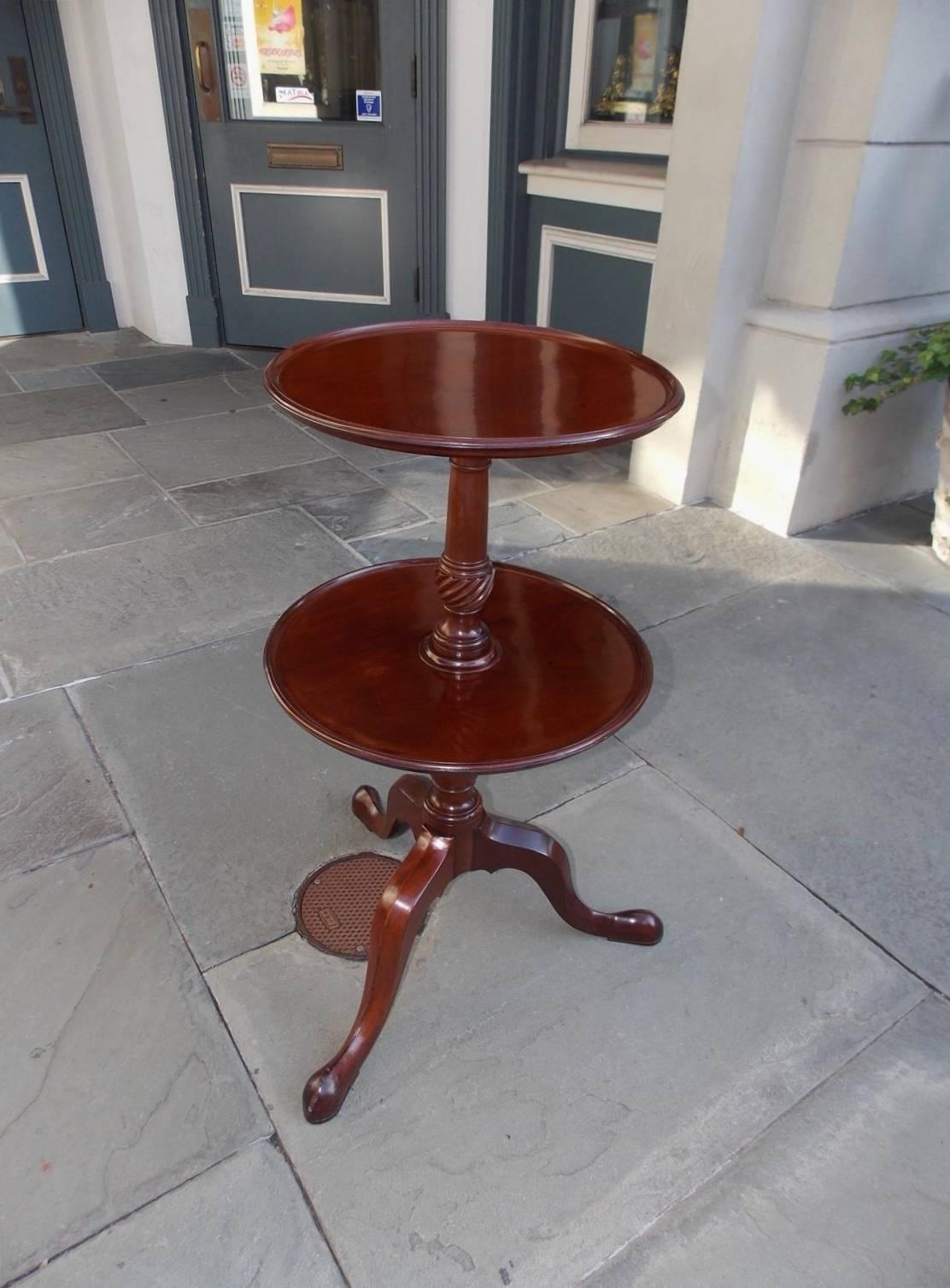 English Chippendale mahogany two-tiered dish top dumb waiter with a carved turned bulbous spiral centered column and terminating on tripod legs with stylized slipper feet, Late 18th century.
