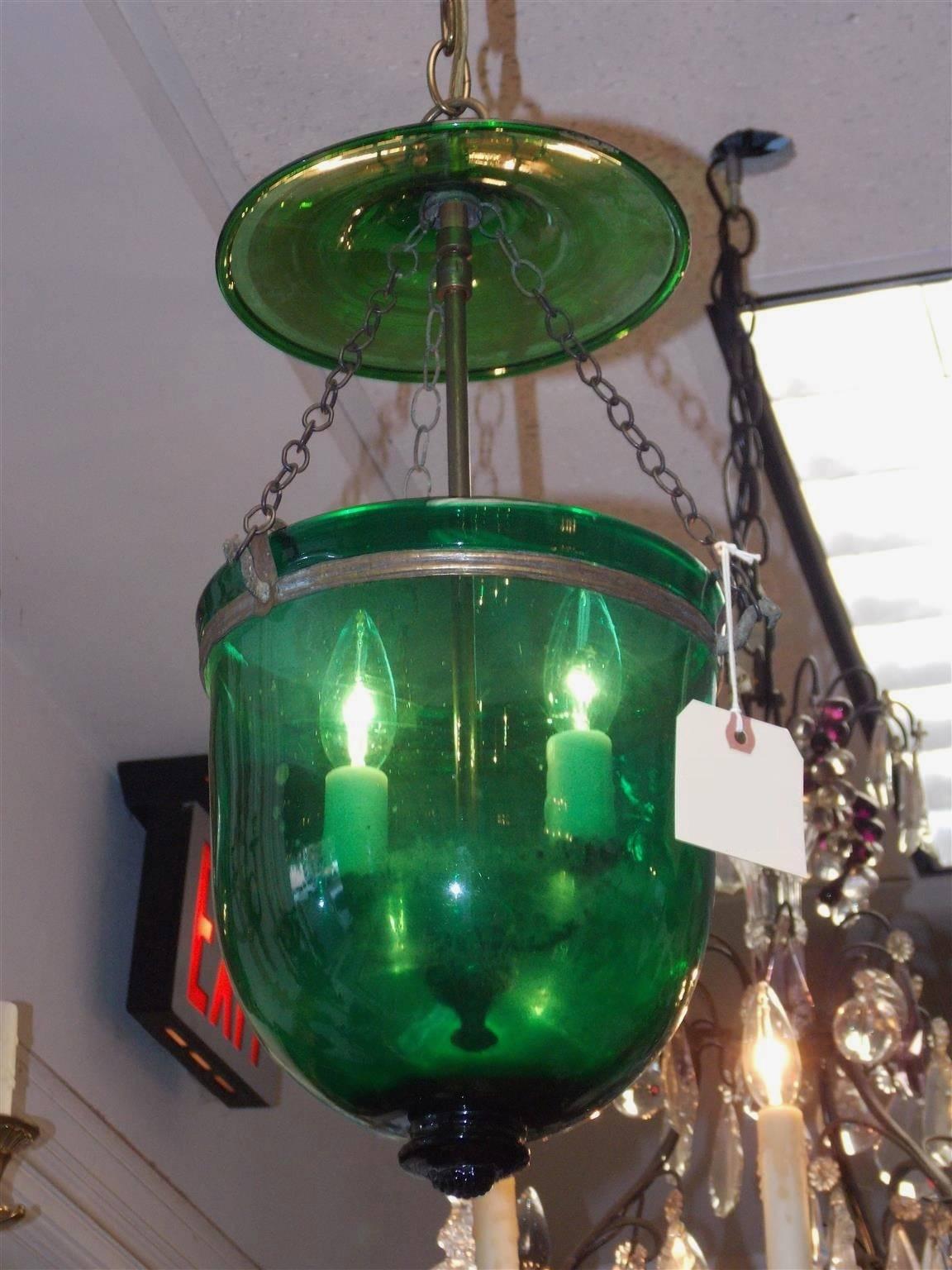 English Emerald green hand blown glass and decorative bronze two-tiered hanging bell jar hall lantern with fitted two light interior cluster. Early 19th Century. Originally candle powered.