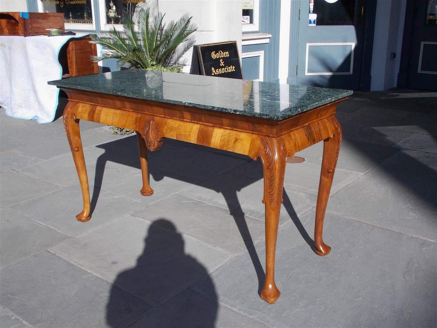 English Walnut Maurin green marble top console with acanthus carved knee, centered acanthus carved cartouche, and terminating on the original trifod stock feet.  Early 19th Century