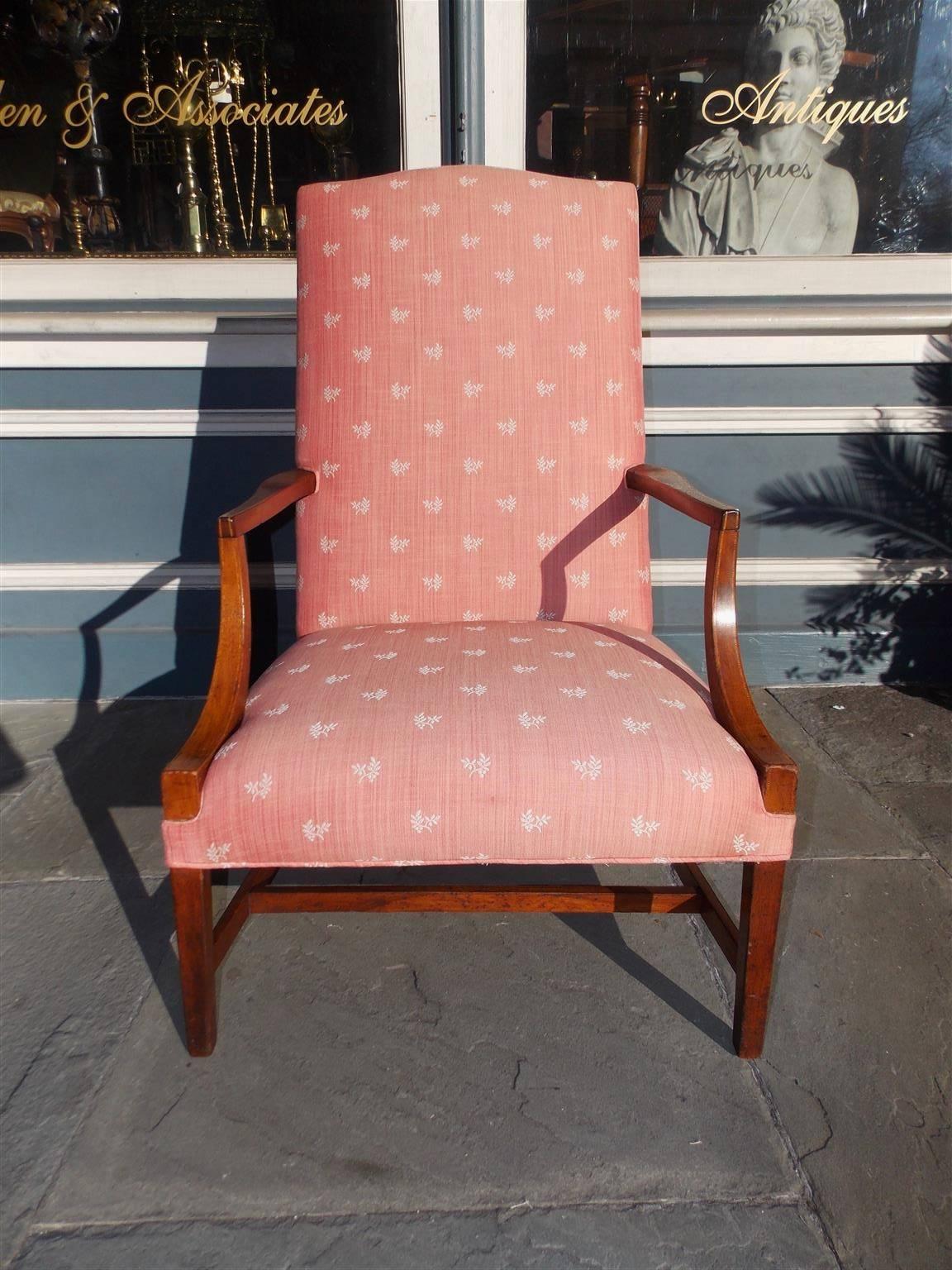 American Hepplewhite mahogany Martha Washington arm chair with a camel back, satinwood inlaid scrolled arms, floral upholstery, and terminating on tapered squared legs with the original connecting stretchers, Late 18th century.