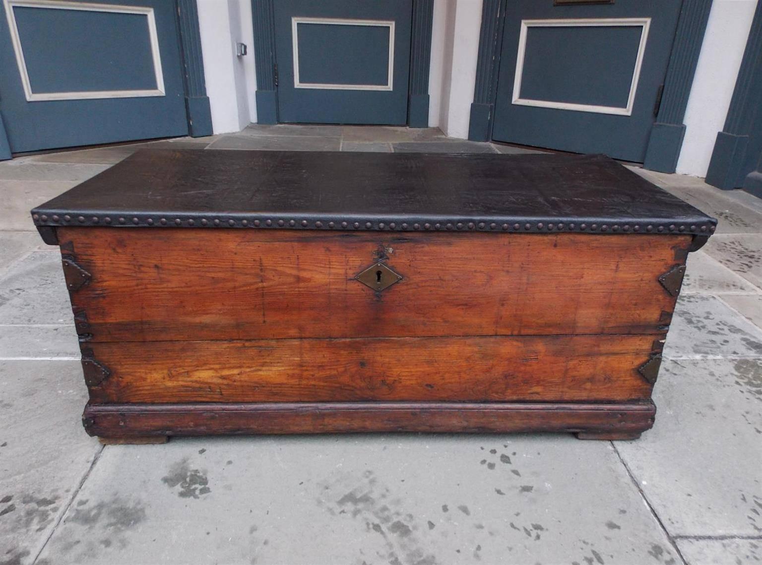 American pine and leather brass studded Nautical sea chest with braided rope beckets, wrought iron side mounts, painted fitted interior with flanking tills, and terminating on a carved molded edge base, Early 19th century.