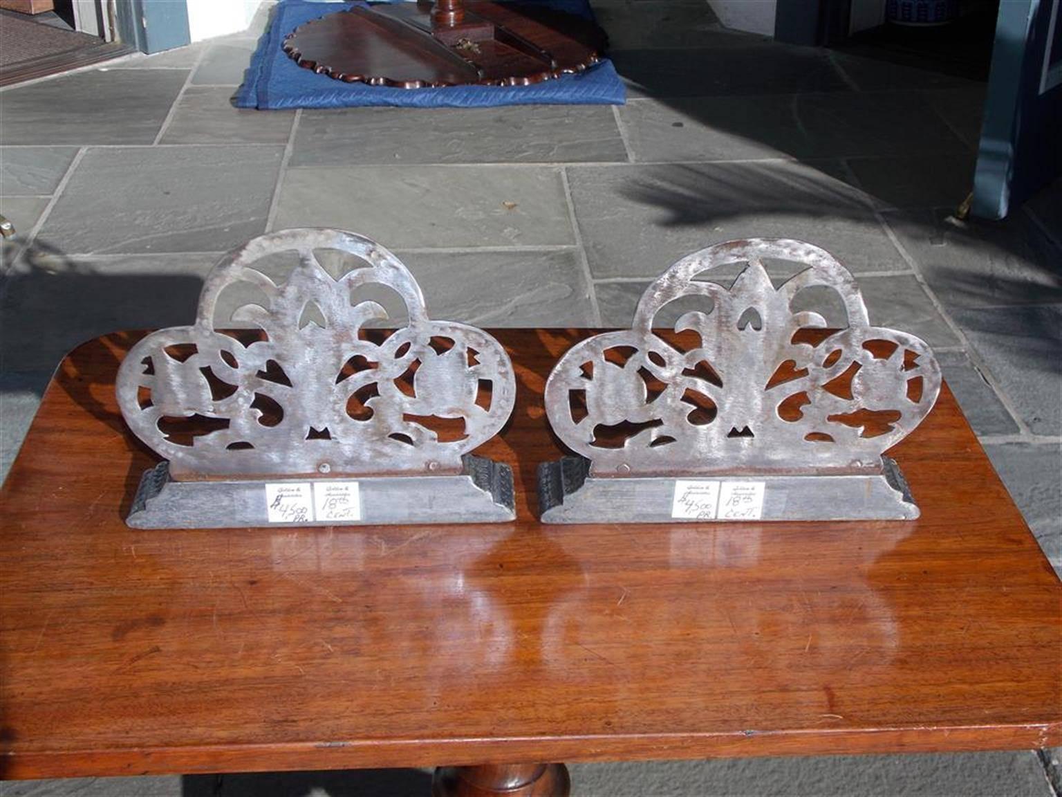 Pair of English polished steel bulbous hand chased decorative floral bookends resting on rectangular step back plinths, Early 19th century.
