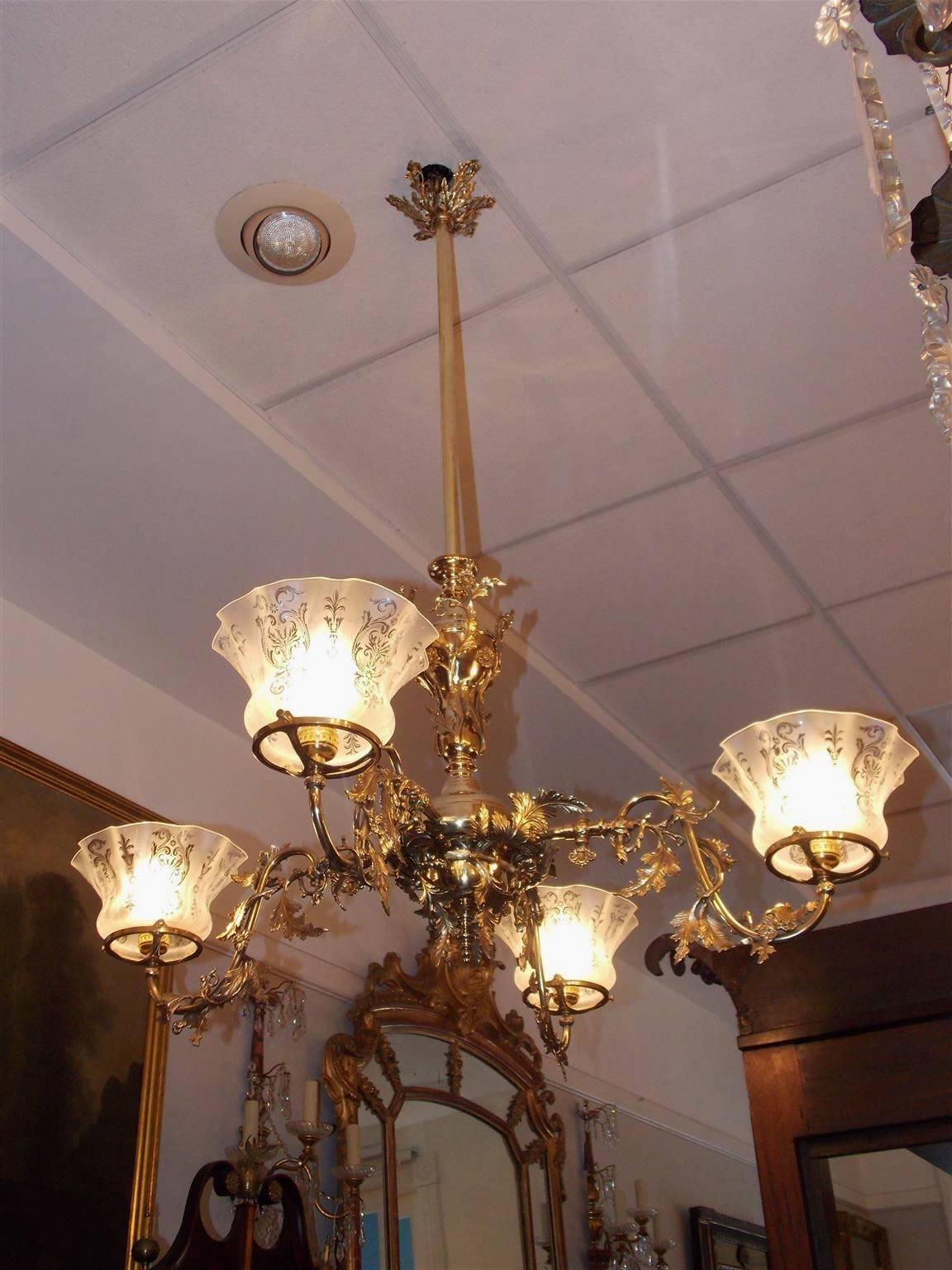 American four-arm gasolier with decorative floral motif, original keys, and the original etched floral frosted globes. Originally gas powered and has been electrified. Mid-19th Century.