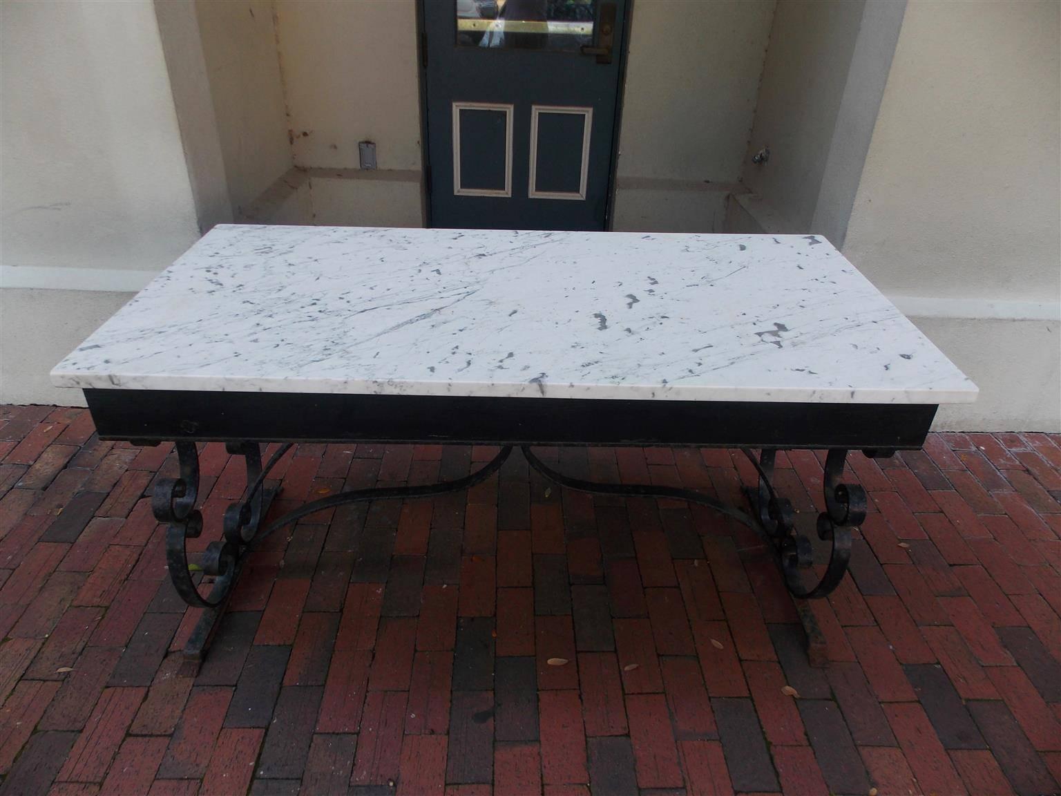 American wrought iron and marble top rectangular console with scrolled legs and connecting stretcher with acanthus leaf motif, Mid-19th century. Skirt height is 24.5
