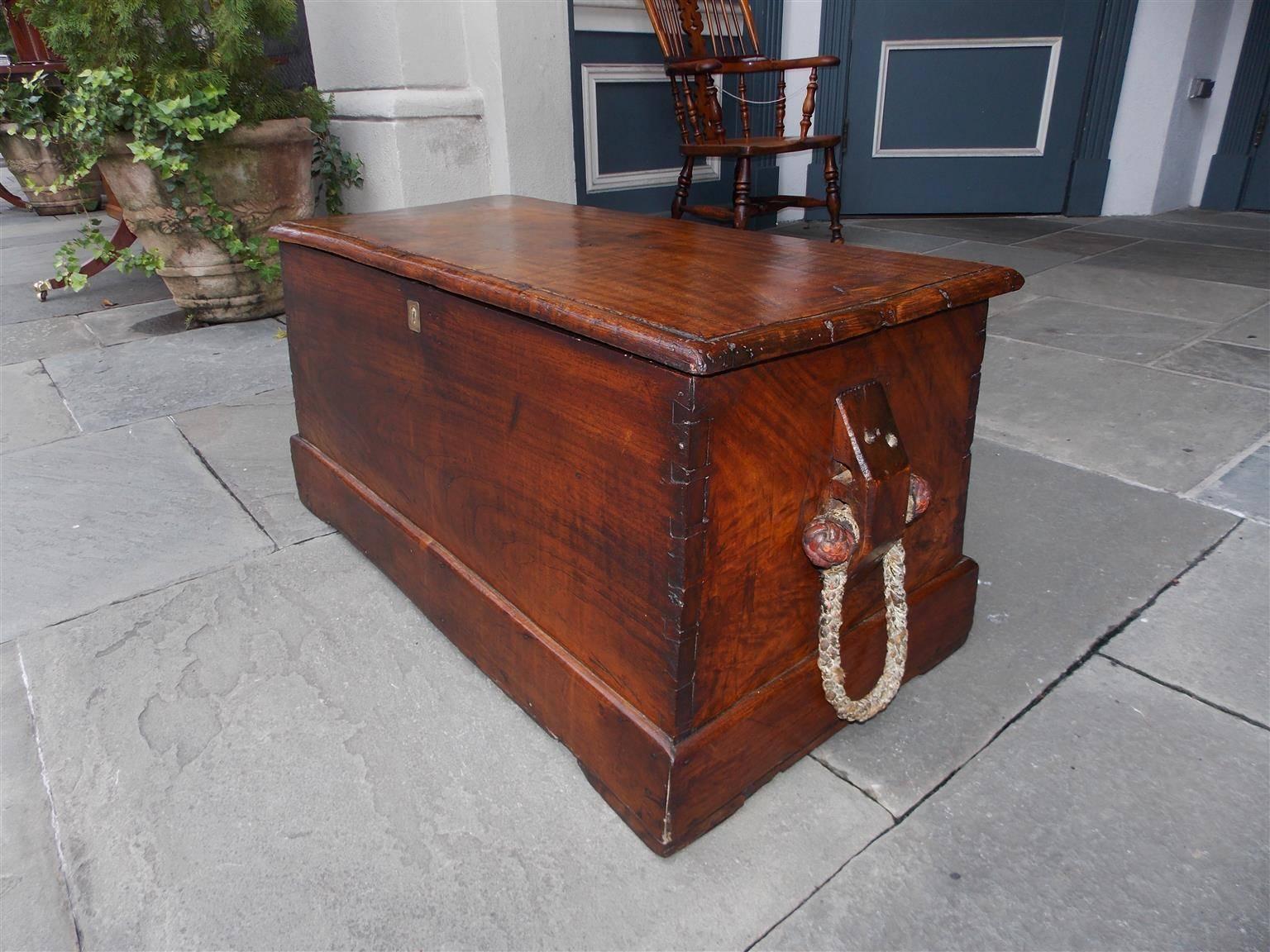 English Camphor wood sea captain's chest with hinged top, exposed corner dovetailing, original mounted braided beckets, and terminating on the original rectangular molded edge  base. Chest is finished on all sides & rope beckets are fabulous. Late