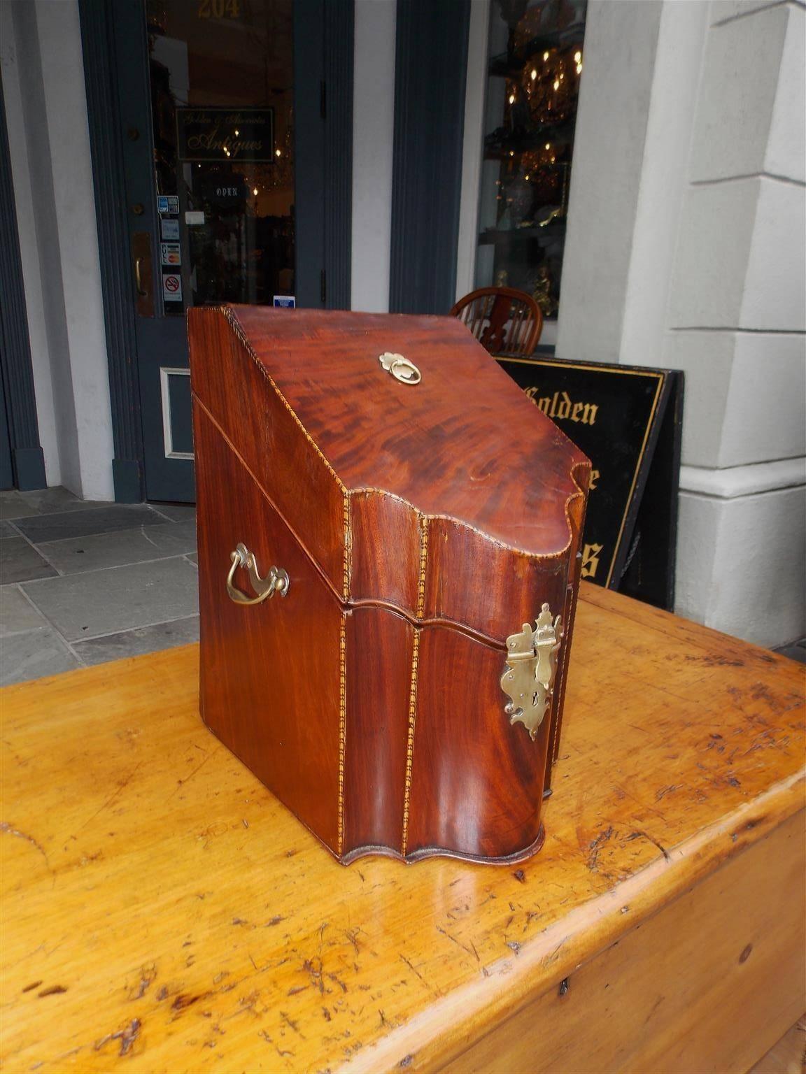 English Georgian mahogany serpentine single knife box with original slotted fitted interior, star and checkered feather banding inlay, adorned with the original brass locking mechanism and side handles, Circa 1770.