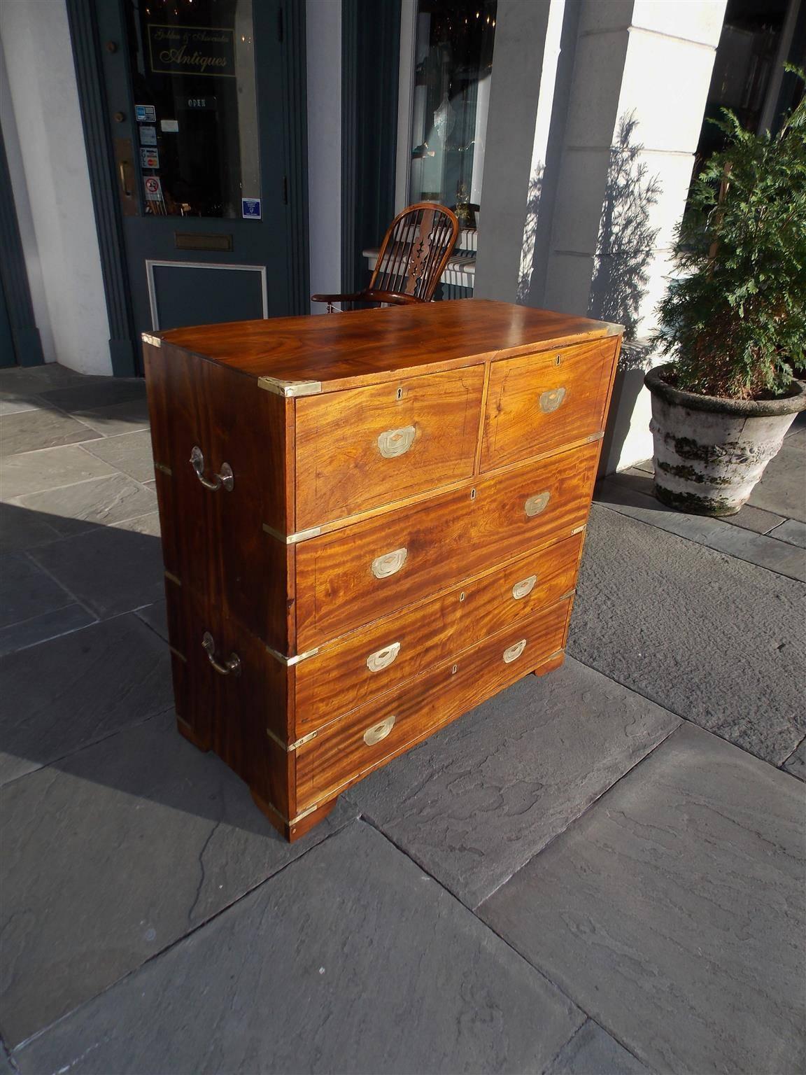 English camphor wood military five-drawer two piece campaign chest with original recessed brasses, brass corner mounts, brass side handles, and terminating on original bracket feet, Early 19th century.
Officers Chest for the field in time of war.