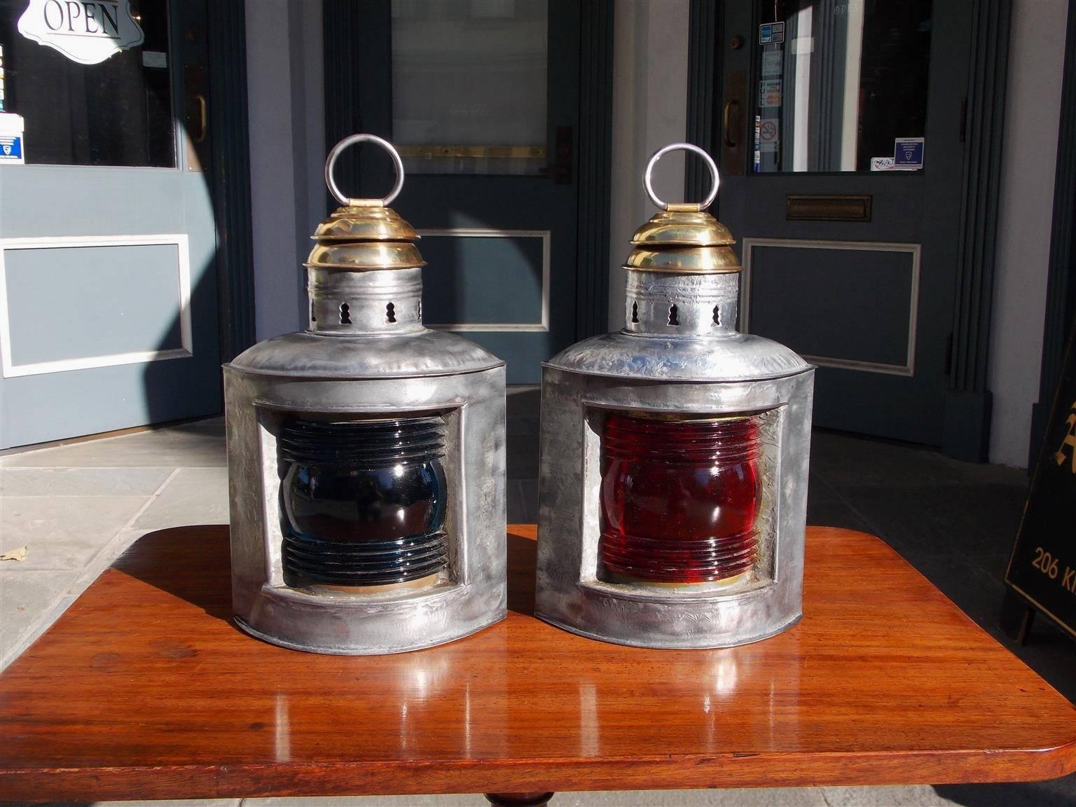 Pair of American polished steel and brass nautical ship lanterns with original port and starboard Fresnel lenses with hoisting rings .  Late 19th Century . 